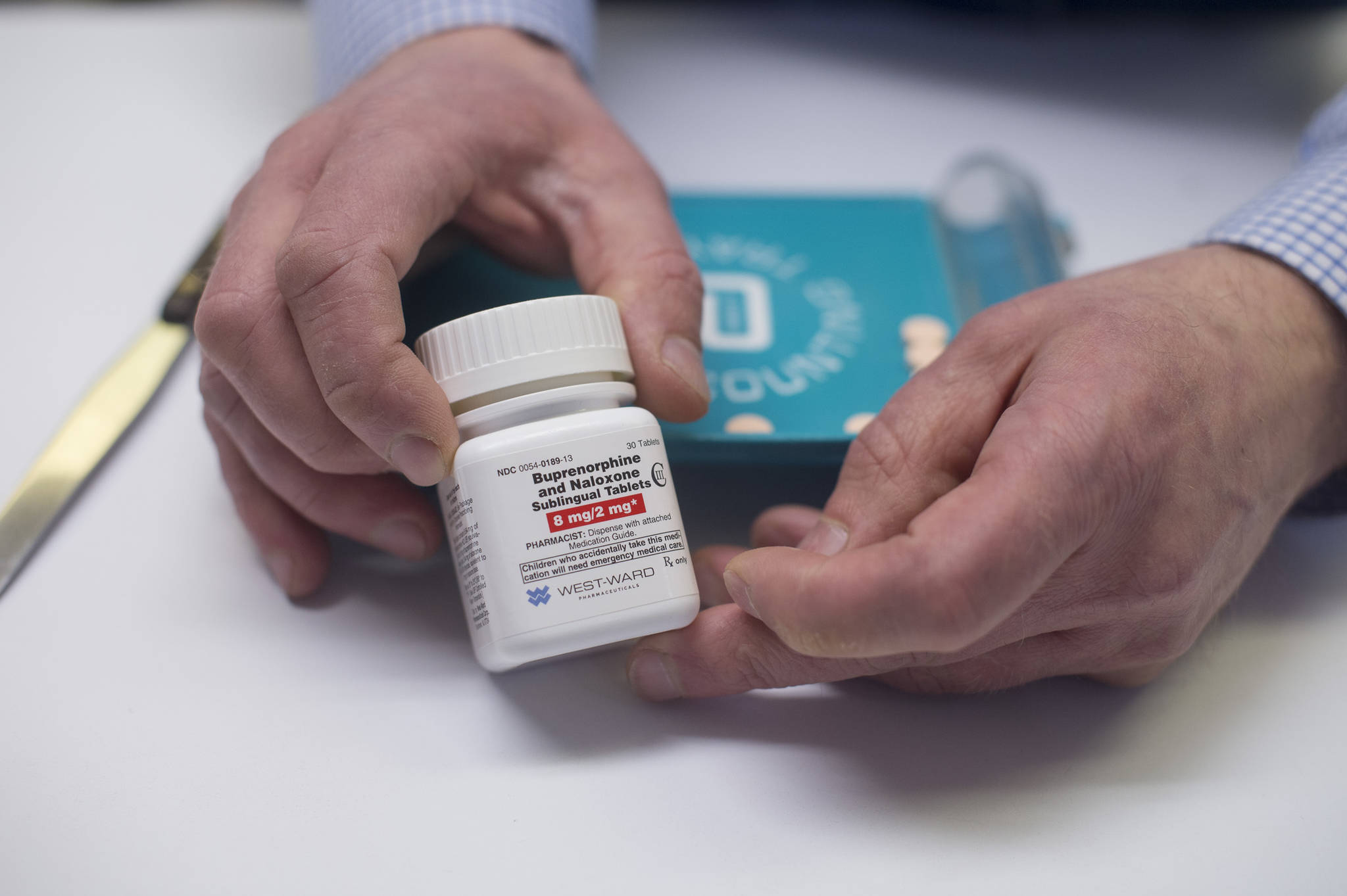 Tim Stifter, pharmacist for Juneau Drug, displays a generic form of Suboxone on Tuesday, May 23, 2017. The drug is used to stabilize brain chemistry in patients suffering from opioid dependency. (Michael Penn/Juneau Empire)