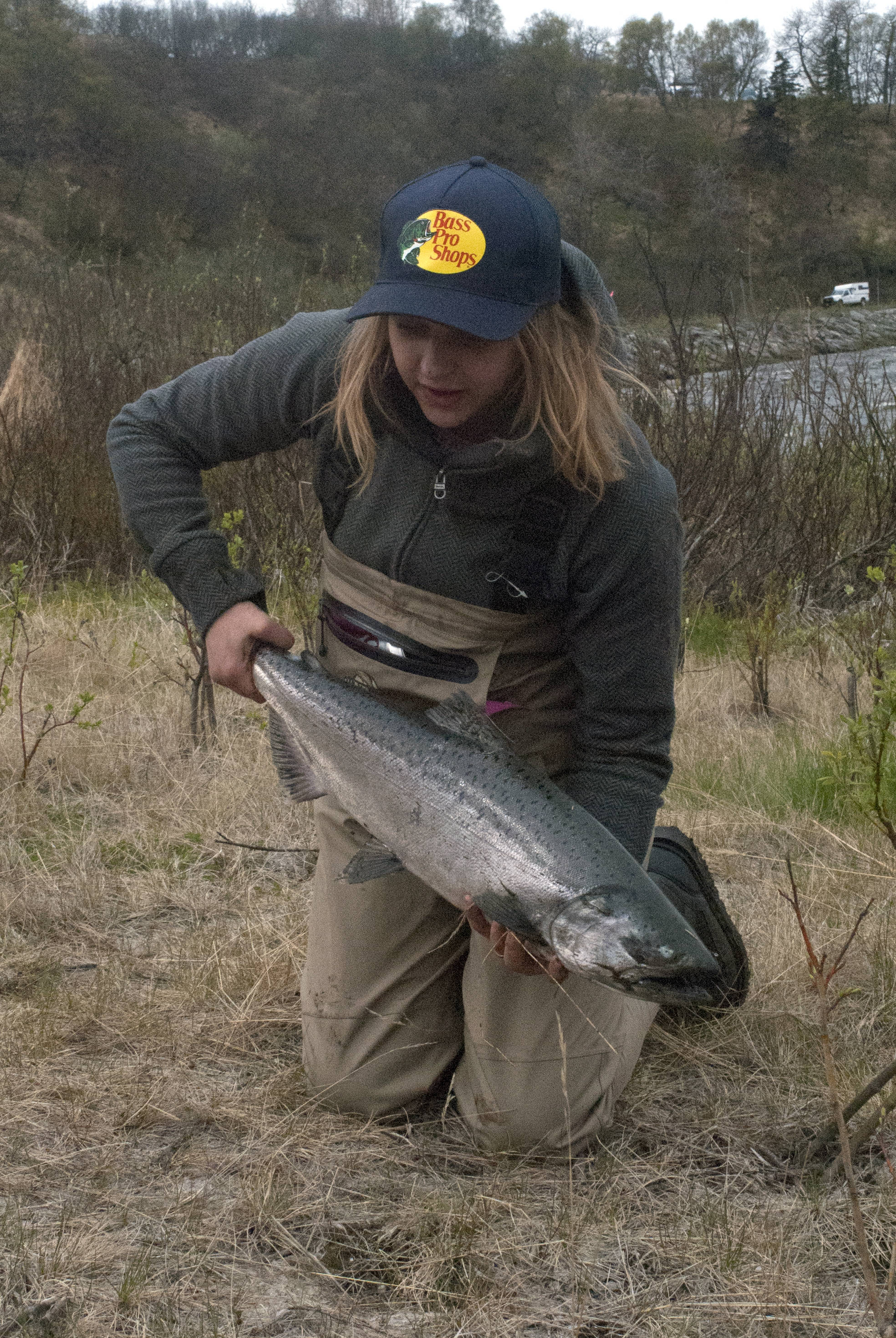 Heather Row of Anchorage prepares to pose for a photo with her freshly caught wild king salmon at the Ninilchik River during the river’s opening weekend on Saturday, May 27 in Ninilchik, Alaska. (Kat Sorensen/Peninsula Clarion)