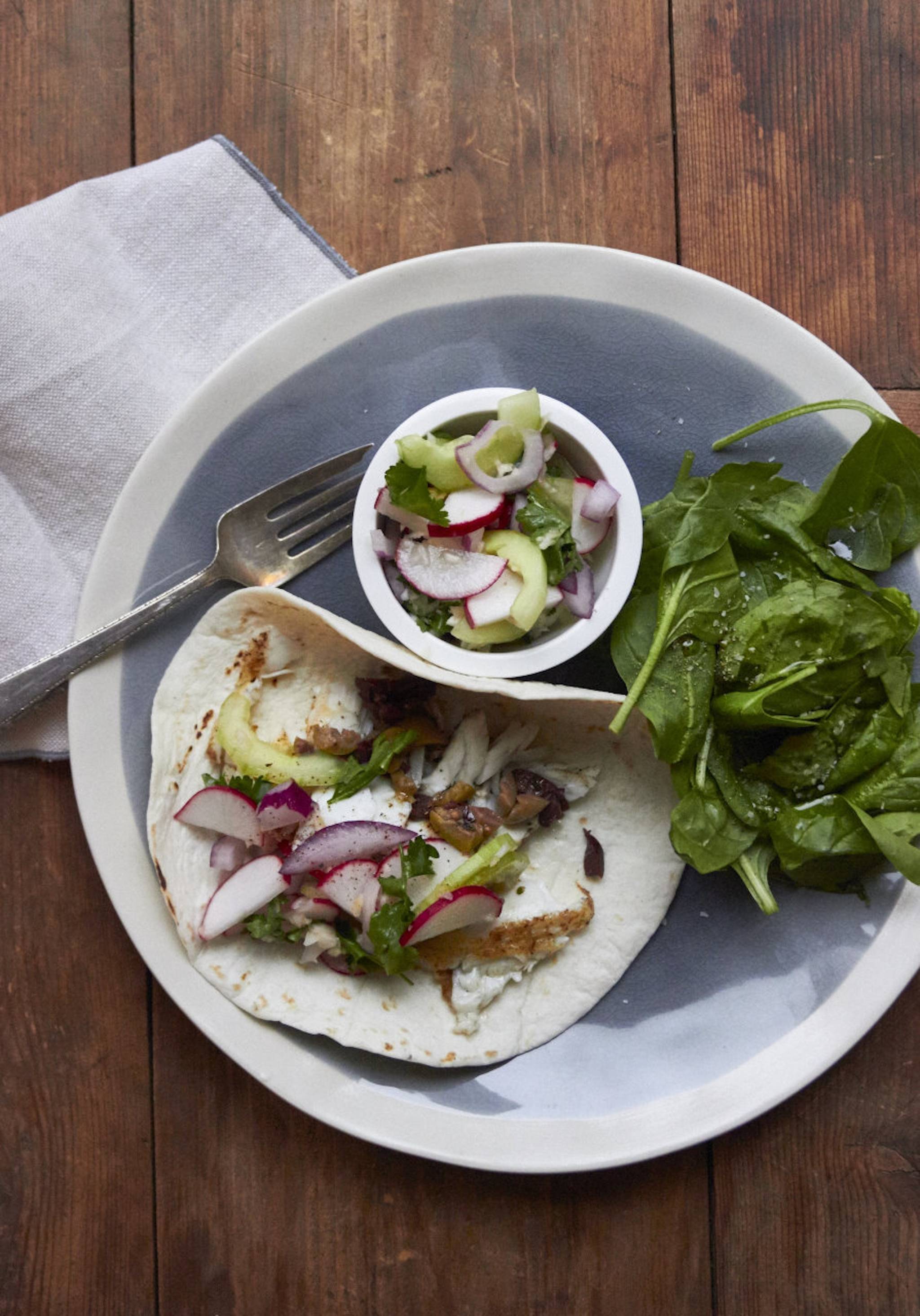 This 2016 photo shows flaky fish tacos in New York. This dish is from a recipe by Katie Workman. (Laura Agra via AP)