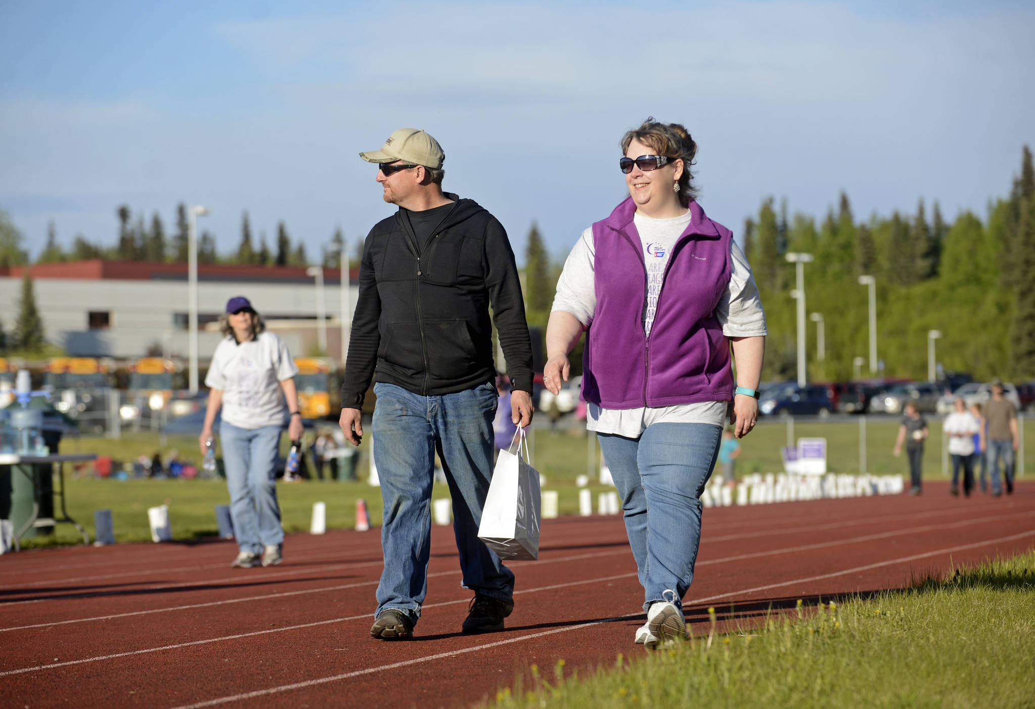 Walkers circle the track during the six-hour Relay for Life fundraiser event for the American Cancer Society on Friday, June 2, 2017 at Skyview Middle School near Soldotna, Alaska. Central peninsula Relay for Life organizer Johna Beech said that this year she began conducting various fundraising events for cancer research in January and will continue until November. (Ben Boettger/Peninsula Clarion)