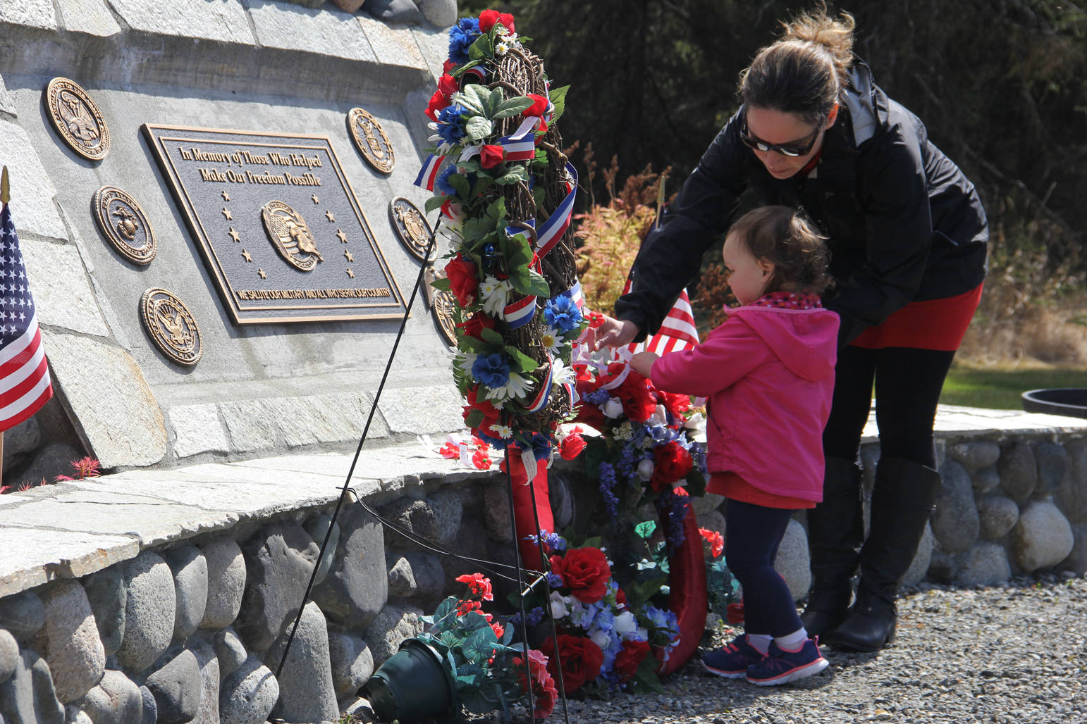 Jane Reynolds teaches 22-month-old Sara to remember the fallen.