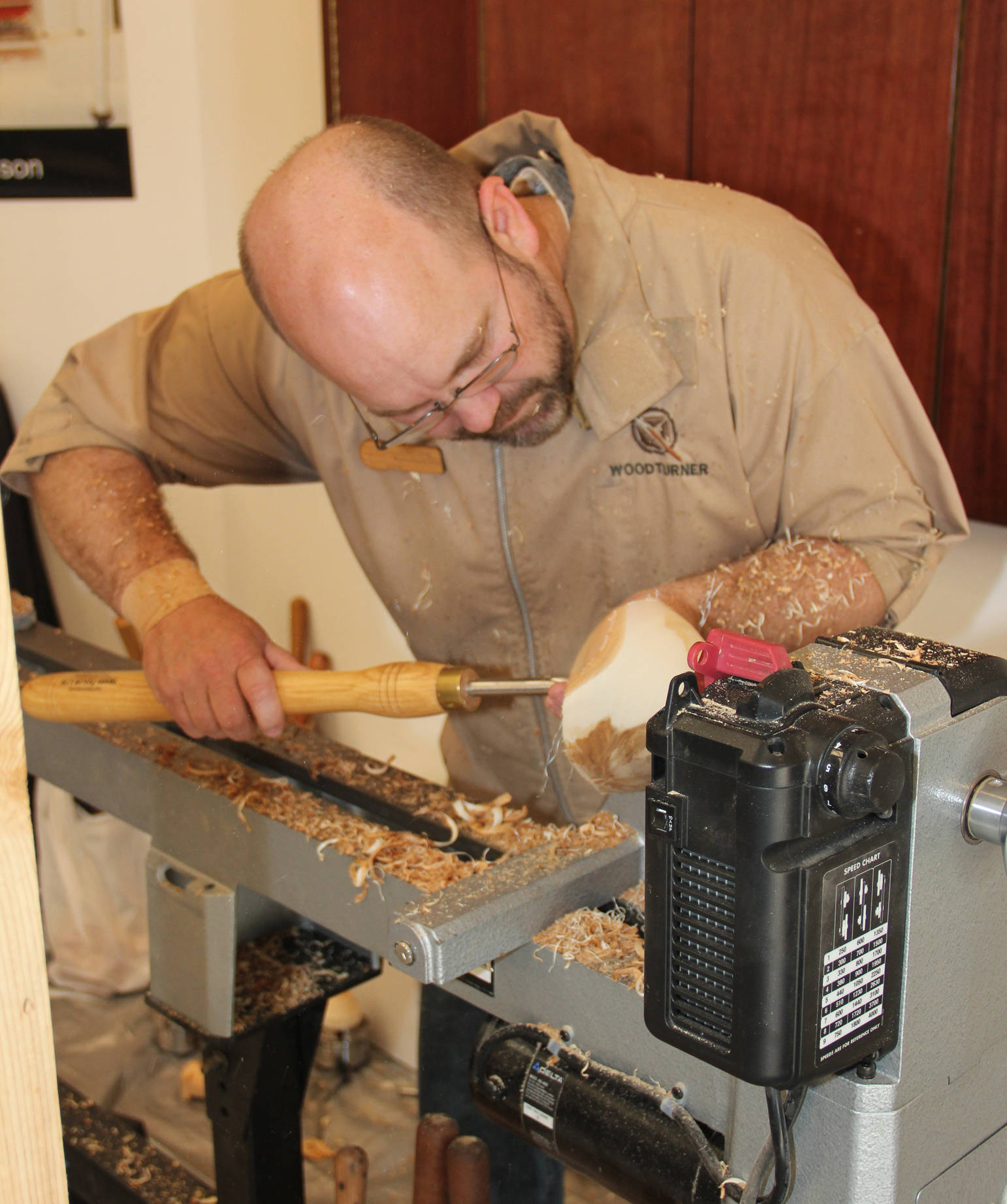 Wood turner Sterling Rasmussen demonstrates bowl turning at KVCC Summer Exhibit opening.