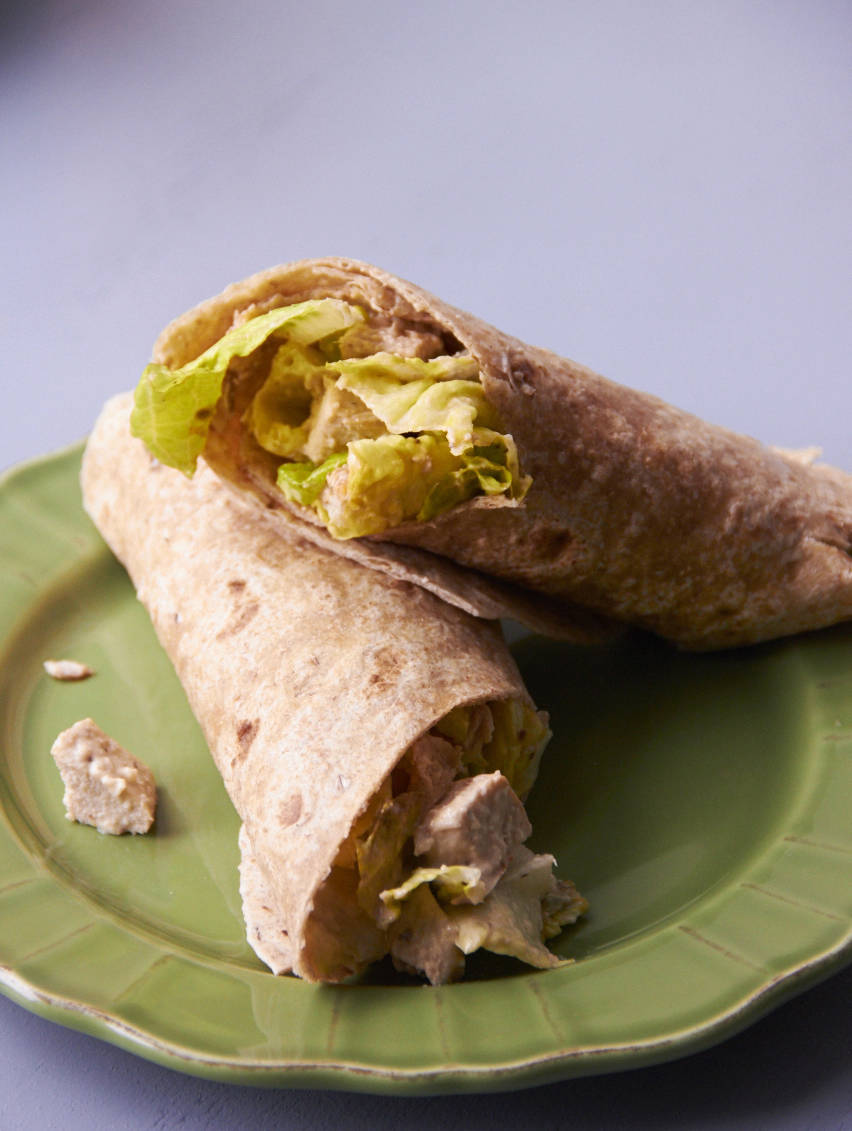 This May photo shows a grilled chicken Caesar wrap in New York. The chicken can be made ahead of time, and leftover chicken can be tossed into salads, either green salads or grain or pasta salads. (Mia via AP)