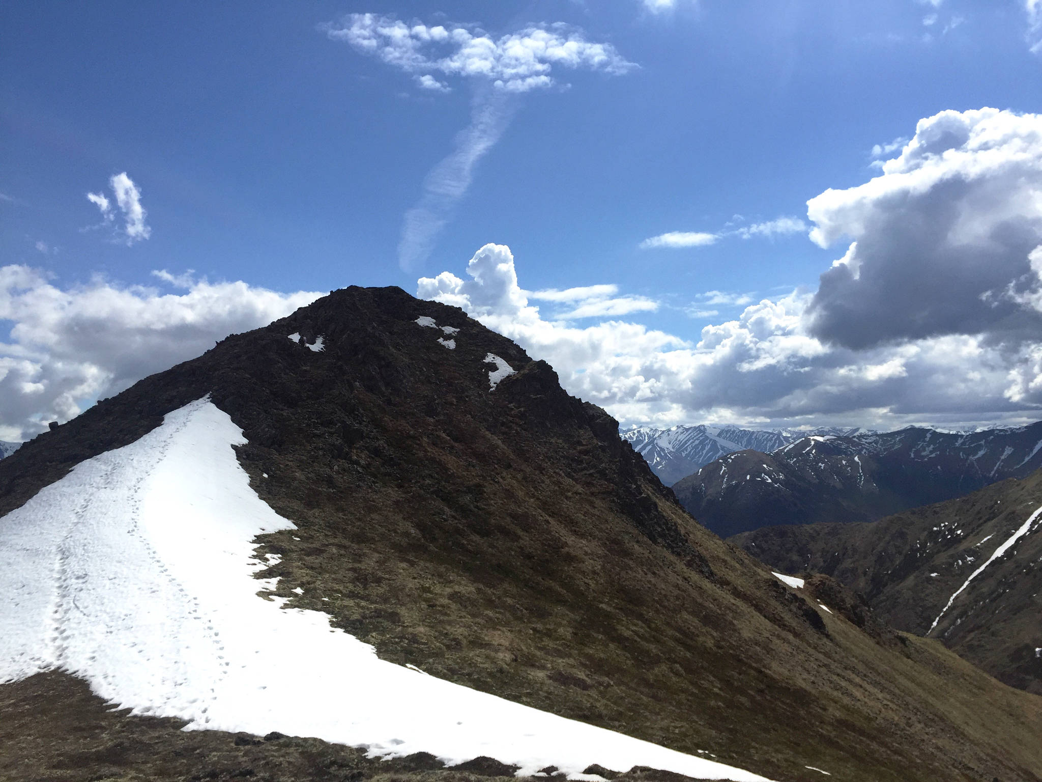 In this Saturday, June 3, 2017 photo taken with a smart phone, a small peak near Hope Point stands out among the clouds near Hope, Alaska. (Elizabeth Earl/Peninsula Clarion)