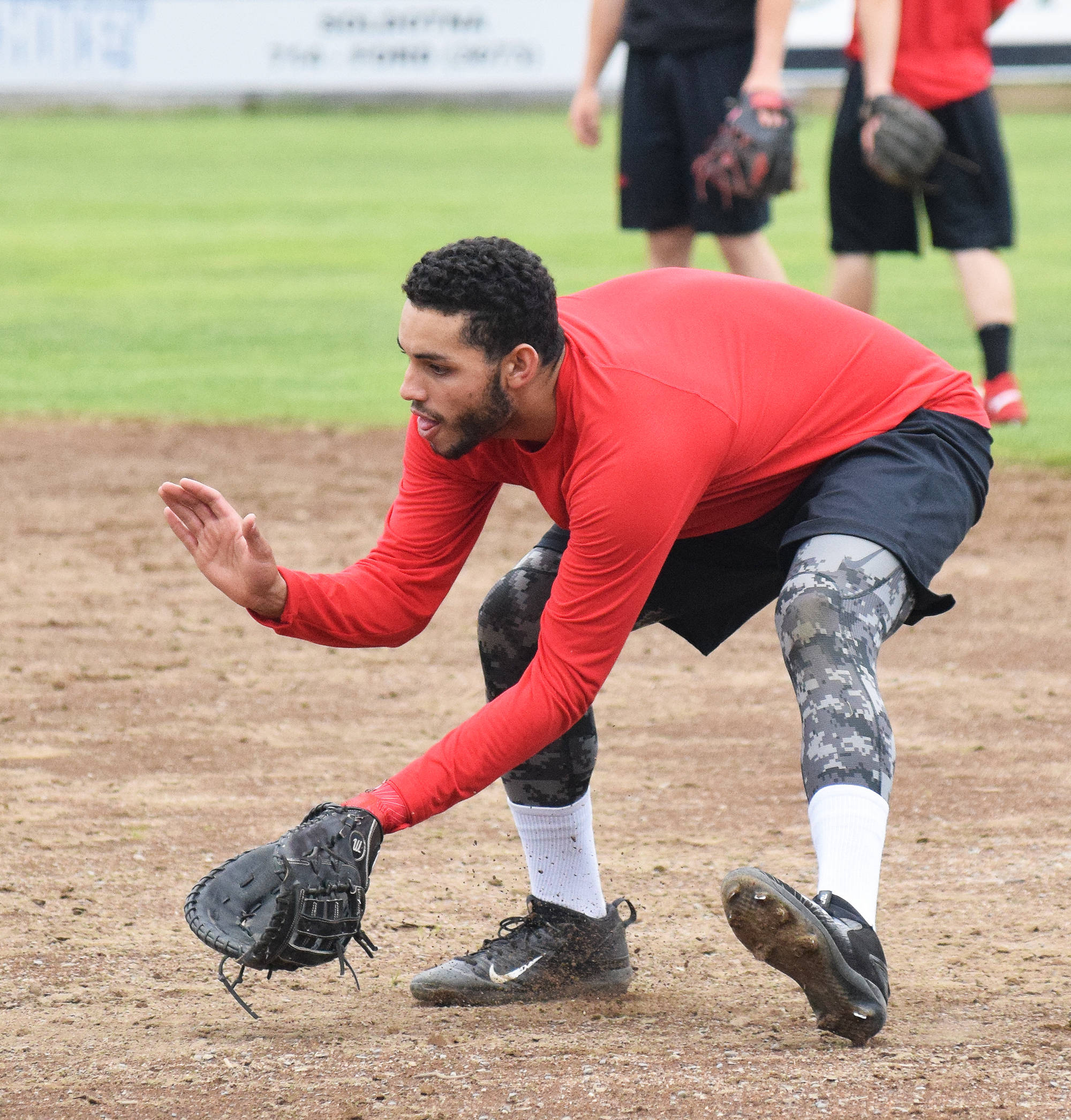 Peninsula Oilers infielder Jonathan Vizcaino scoops up a ground ball during batting practice Thursday in preparation of Friday’s season opener. (Photo by Joey Klecka/Peninsula Clarion)