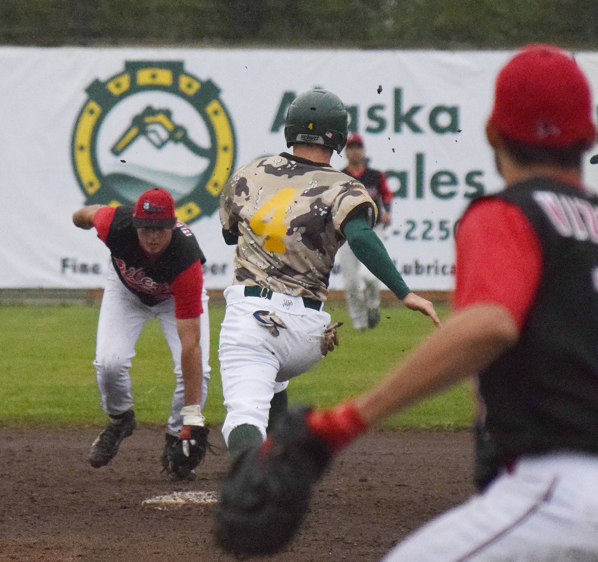 Mat-Su baserunner Austin Dennis races to second while Peninsula Oilers shorstop Caleb Hicks (21) attempts the putout Friday night at Coral Seymour Memorial Park in Kenai. (Photo by Joey Klecka/Peninsula Clarion)