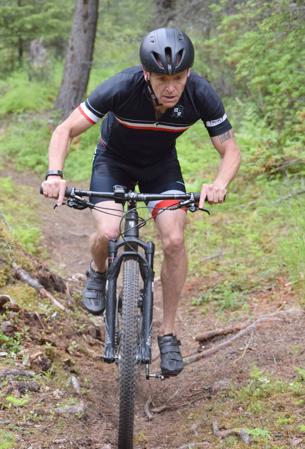 Mike Crawford negotiates roots on the singletrack portion of the bike leg at the Snippit Loppet Duathlon on Sunday, June 11, 2017, at Tsalteshi Trails. (Photo by Jeff Helminiak/Peninsula Clarion)