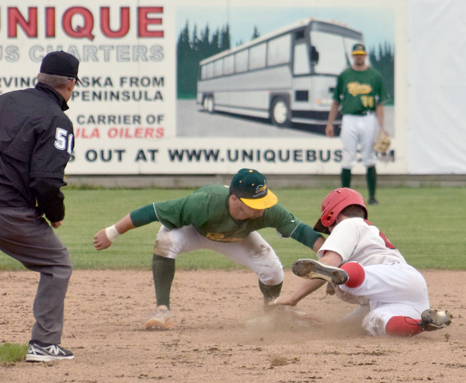 Oilers’ Kellen Strahm slides under the tag of Miners second baseman Brandon Chinea for a stolen base in the bottom of the third inning of Game 2 of the doubleheader Sunday, June 11, 2017, at Coral Seymour Memorial Park in Kenai. (Photo by Jeff Helminiak/Peninsula Clarion)