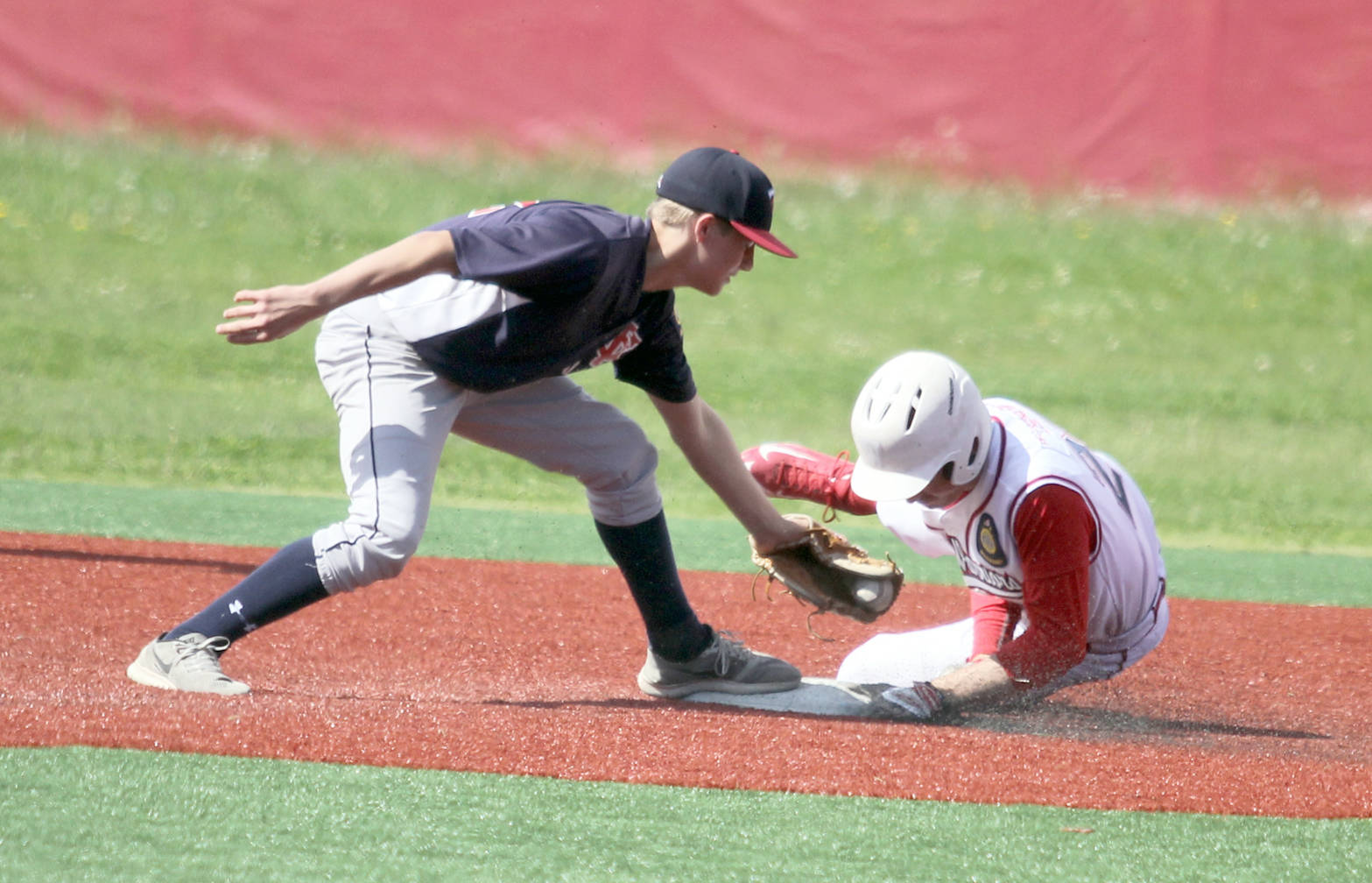 Kenai infielder Porter Fannon tries to tag Wasilla’s Ben Werner at second during a 13-3 loss to the Road Warriors on Wednesday, June 14, 2017, at Wasilla High School. (Photo by Jeremiah Bartz/Frontiersman)