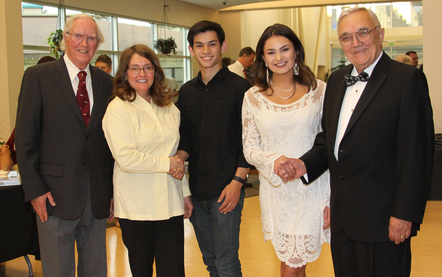 Dr. Russell, Joan Corr and Ed Krohn congratulate Dr. Isaak Scholars Jonathan Standerfer and Sophia Sorensen.