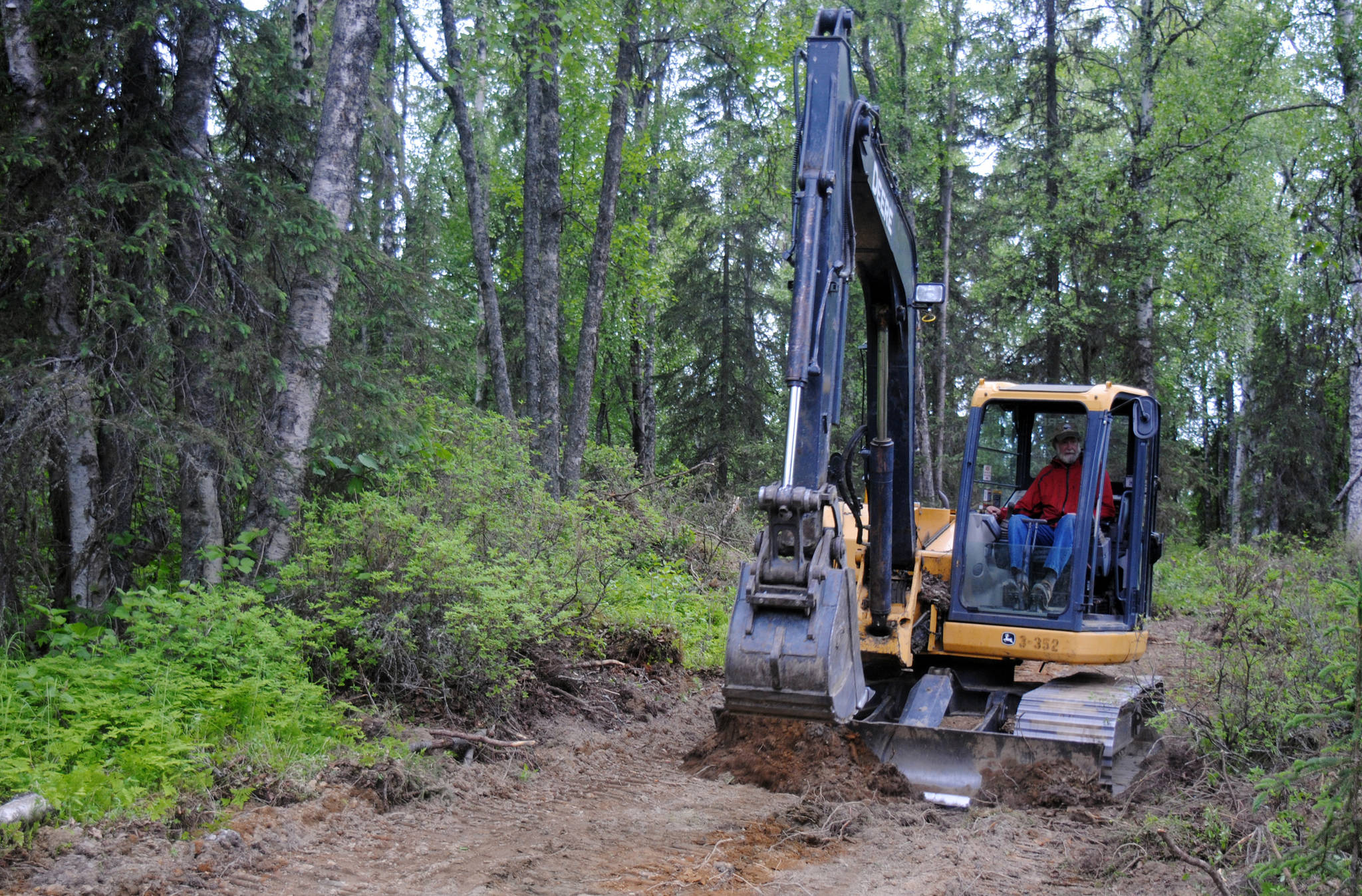 Tsalteshi Trails Maintenance Manager Bill Holt explores the newest edition to the organization’s trail system, a parcel of land to the west of the Sterling Highway on Monday, June 19, 2017 outside Soldotna, Alaska. (Kat Sorensen/Peninsula Clarion)