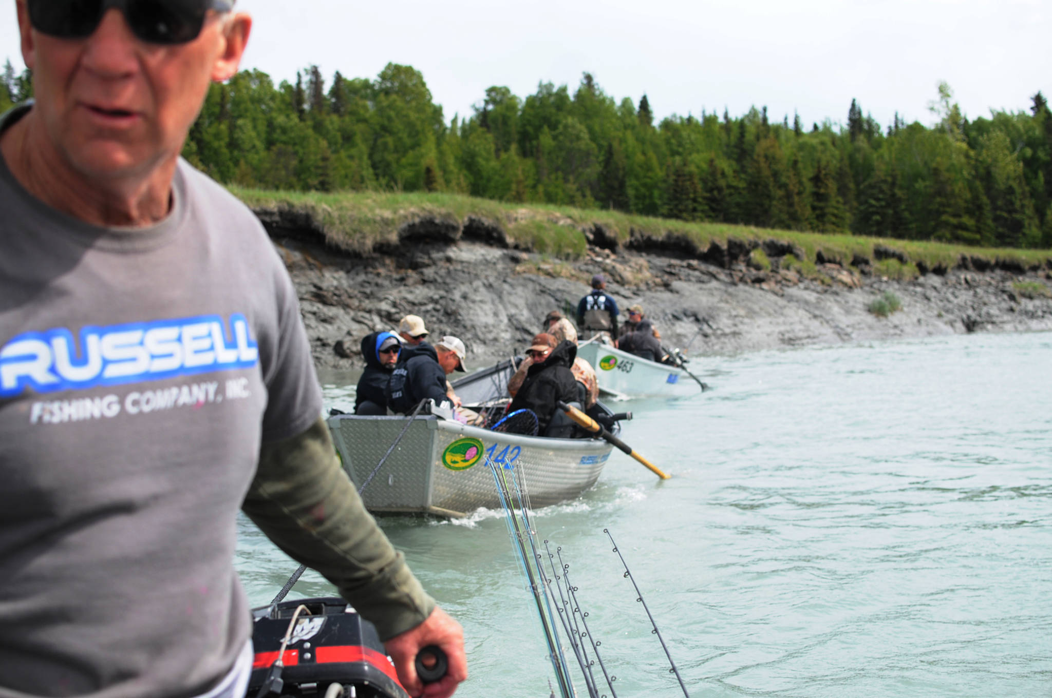 Bill Russell, a fishing guide with Russell Fishing Company, tows two boats full of clients down the Kasilof River toward the boat retrieval system at the Kasilof River Lodge and Cabins on Monday, June 19, 2017 in Kasilof, Alaska. Motors are prohibited on the Kasilof River above a marker at approximately river mile 3, and are limited to 10 horsepower below that. Once a motor goes in the water, guided clients have to draw up their lines and be done with fishing for the day as well. With plans for at state takeout facility at approximately river mile 3.75 stalled, guides have only one option for taking out of the lower Kasilof River, which can sometimes lead to long waits. ((Photo by Elizabeth Earl/Peninsula Clarion)