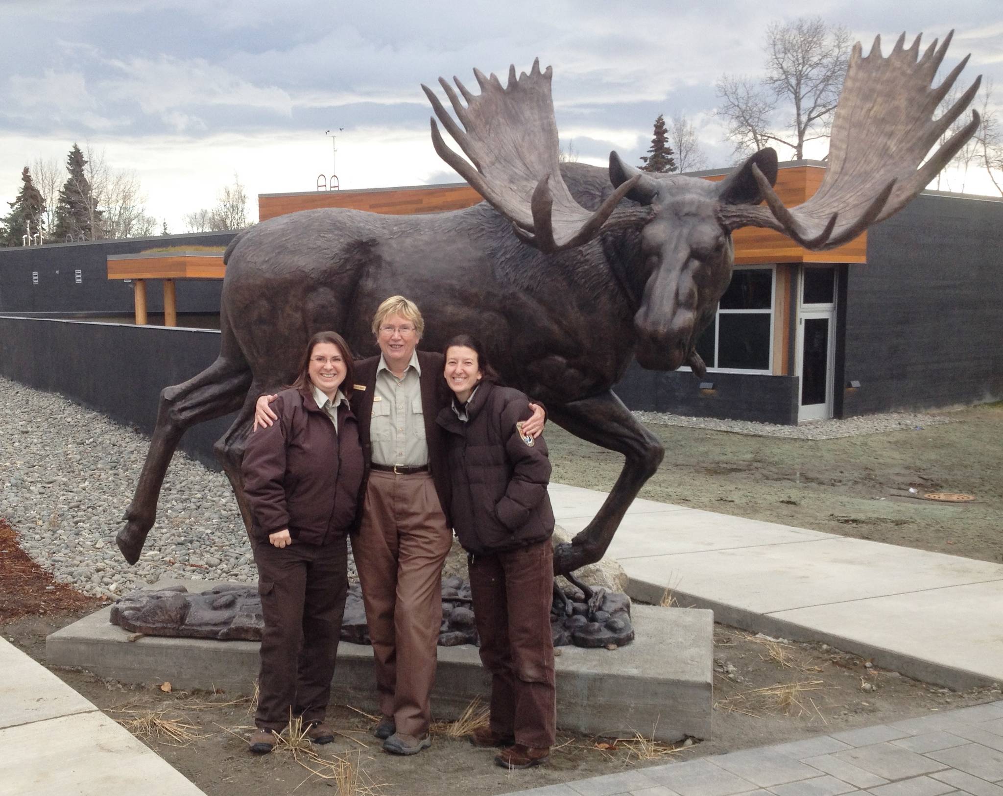 Retiring Park Ranger Candace Ward (center) with her dynamic colleagues, Leah Eskelin (left) and Michelle Ostrowski (right) in front of Majesty the Moose (back). (Photo courtesy Kenai National Wildlife Refuge)