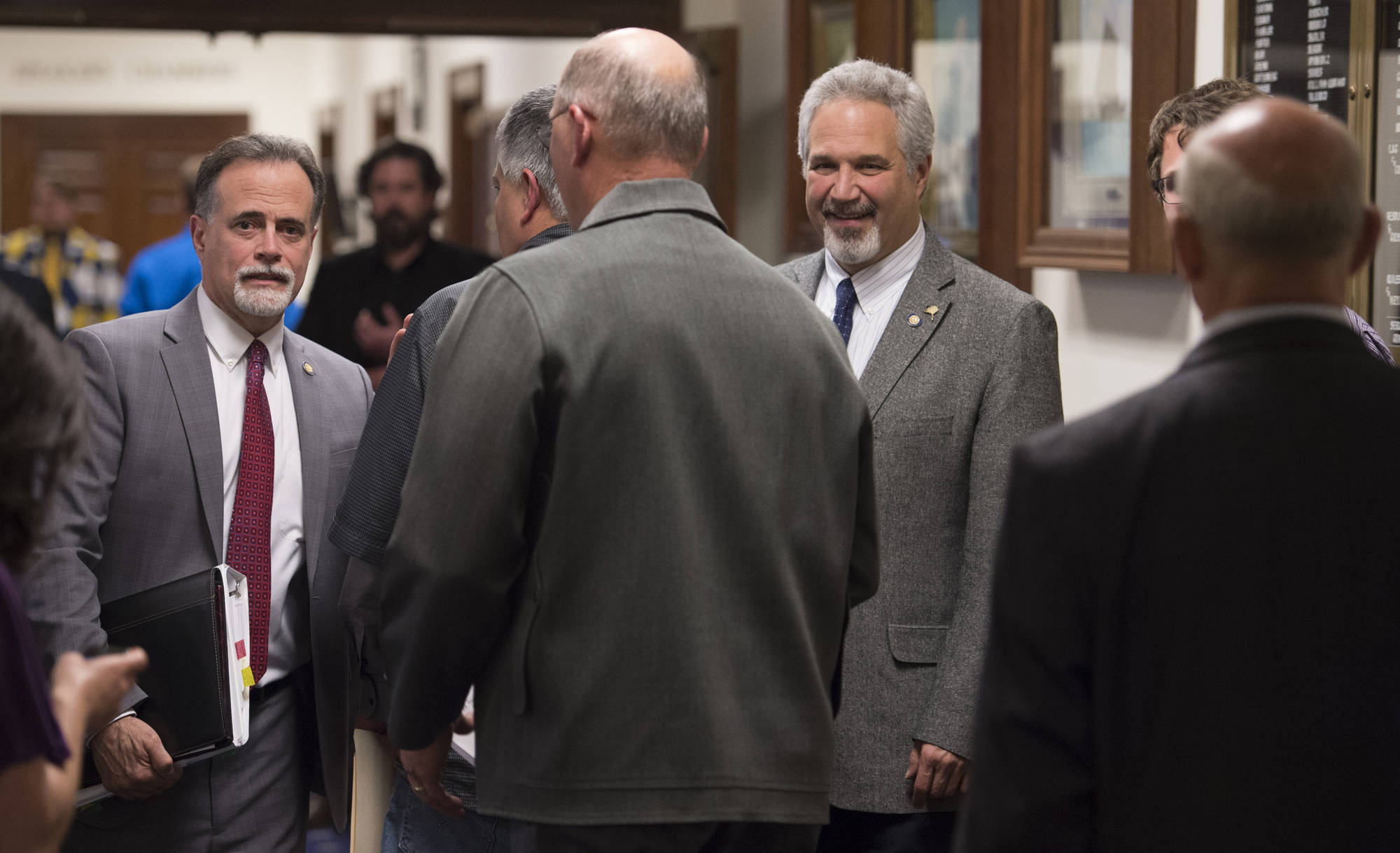 Senators gather in the hallway of the Capitol on Thursday, June 22, 2017, after passing a budget that will keep that the State of Alaska from shutting down on July 1. (Michael Penn | Juneau Empire)