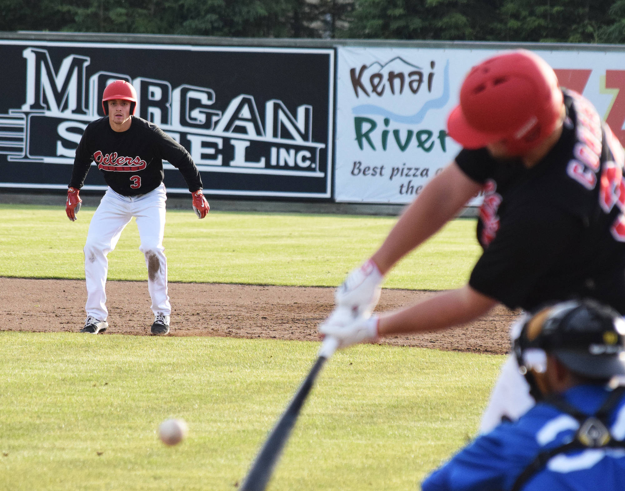 Peninsula Oilers baserunner Oliver Dunn (3) keeps an eye on teammate Jeremy Conant Friday evening at Coral Seymour Memorial Park in Kenai. (Photo by Joey Klecka/Peninsula Clarion)