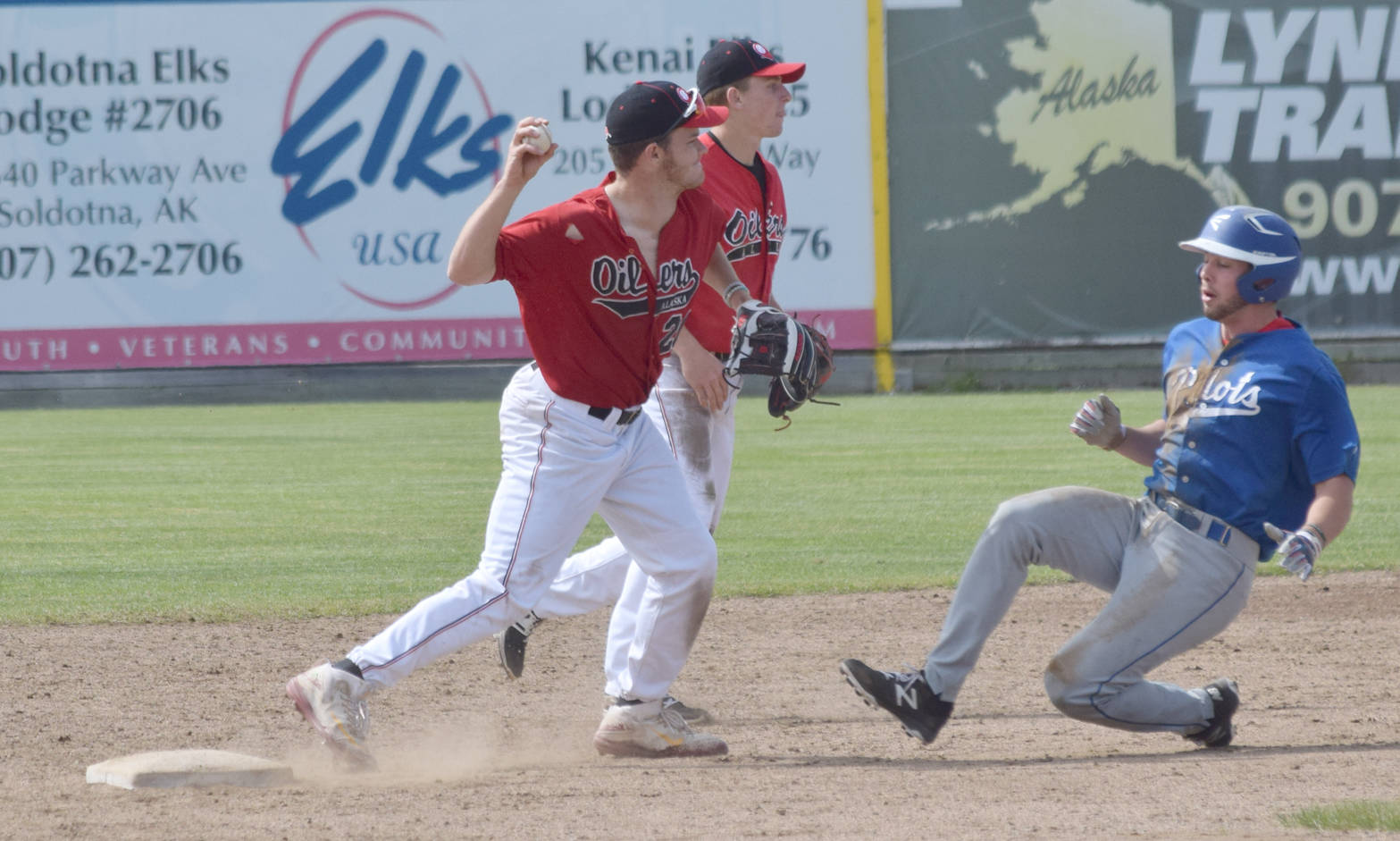 Oilers shortstop John Thomas forces out Carter Bins of the Glacier Pilots at second base Sunday, June 25, 2017, at Coral Seymour Memorial Park in Kenai. (Photo by Jeff Helminiak/Peninsula Clarion)