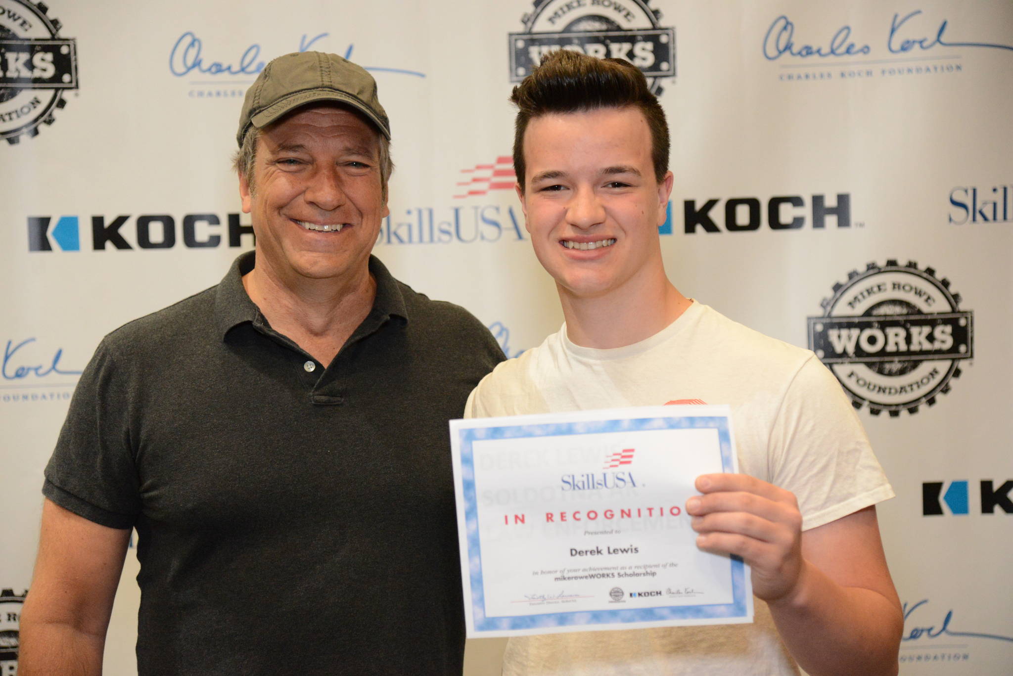 Derek Lewis, a Soldotna High School student, poses for a photo with Mike Rowe at a luncheon hosted by mikeroweWORKS, before the national SkillsUSA competition.  Photo &