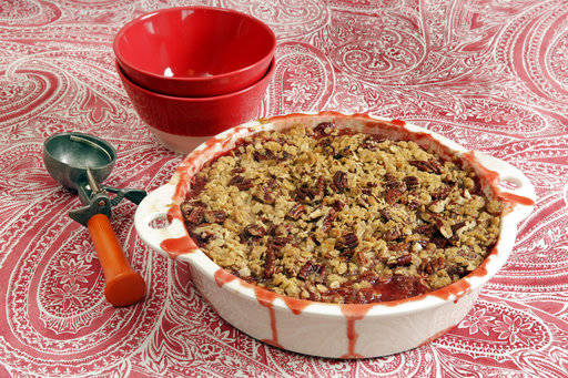This May 24 photo shows a strawberry-rhubarb crisp at the Institute of Culinary Education in New York. This dish is from a recipe by Elizabeth Karmel. (AP Photo/Richard Drew)