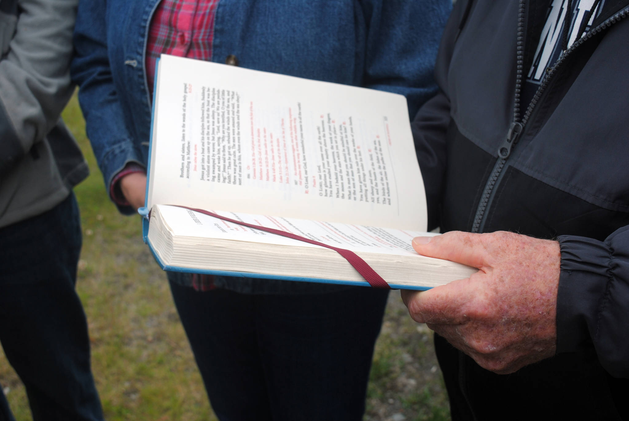 Father Roger Bergkamp of Our Lady of Perpetual Help in Soldotna reads a blessing during the Blessing of the Fleet on Friday, June 30, 2017 in Kenai, Alaska. (Photo by Kat Sorensen/Peninsula Clarion)