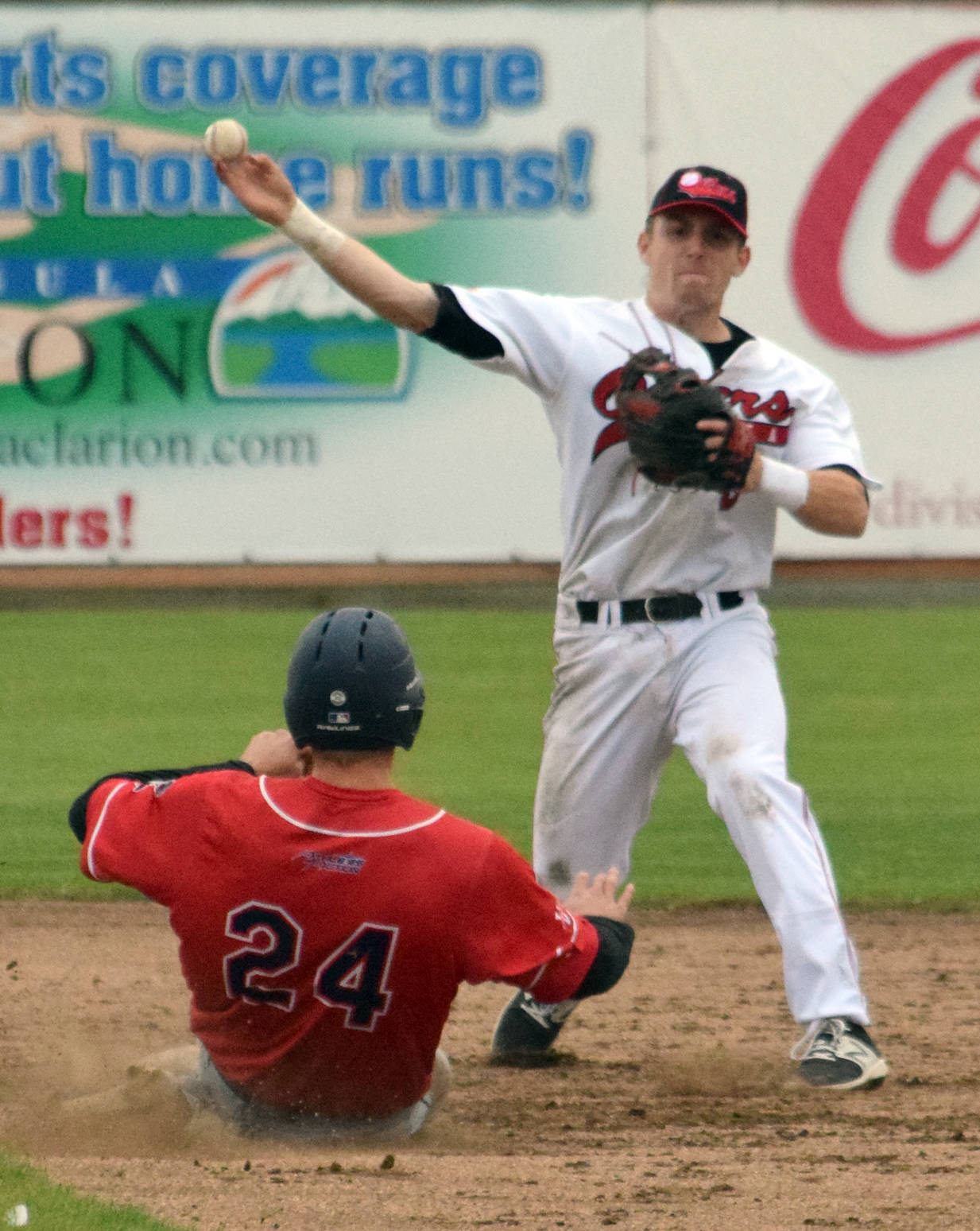 Peninsula Oilers second baseman Oliver Dunn turns a double play in front of the slide of Micah Pries of the Chugiak-Eagle River Chinooks in the fifth inning Friday, June 30, 2017, at Coral Seymour Memorial Park in Kenai. (Photo by Jeff Helminiak/Peninsula Clarion)