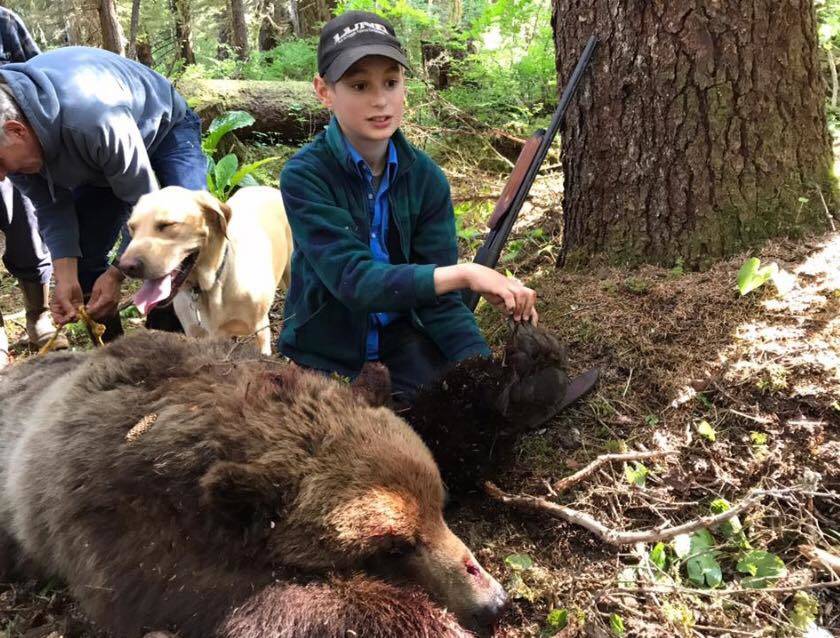 Elliot Clark and family with a brown bear he shot after it charged a group of hunters near Hoonah. (Photo courtesy Sen. Shelly Hughes’ Facebook page)