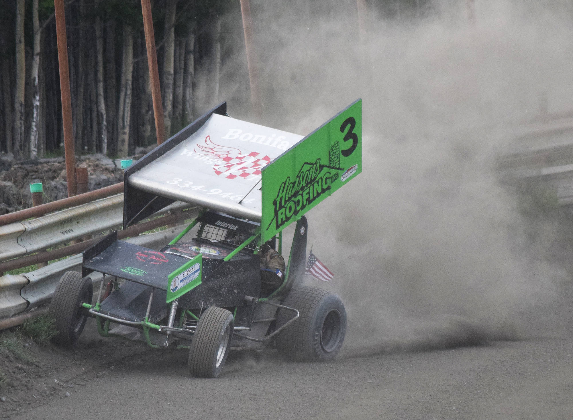Sprint car driver Geoff Clark smacks the outside barrier during the Sprint feature event Saturday night at Twin City Raceway in Kenai. (Photo by Joey Klecka/Peninsula Clarion)