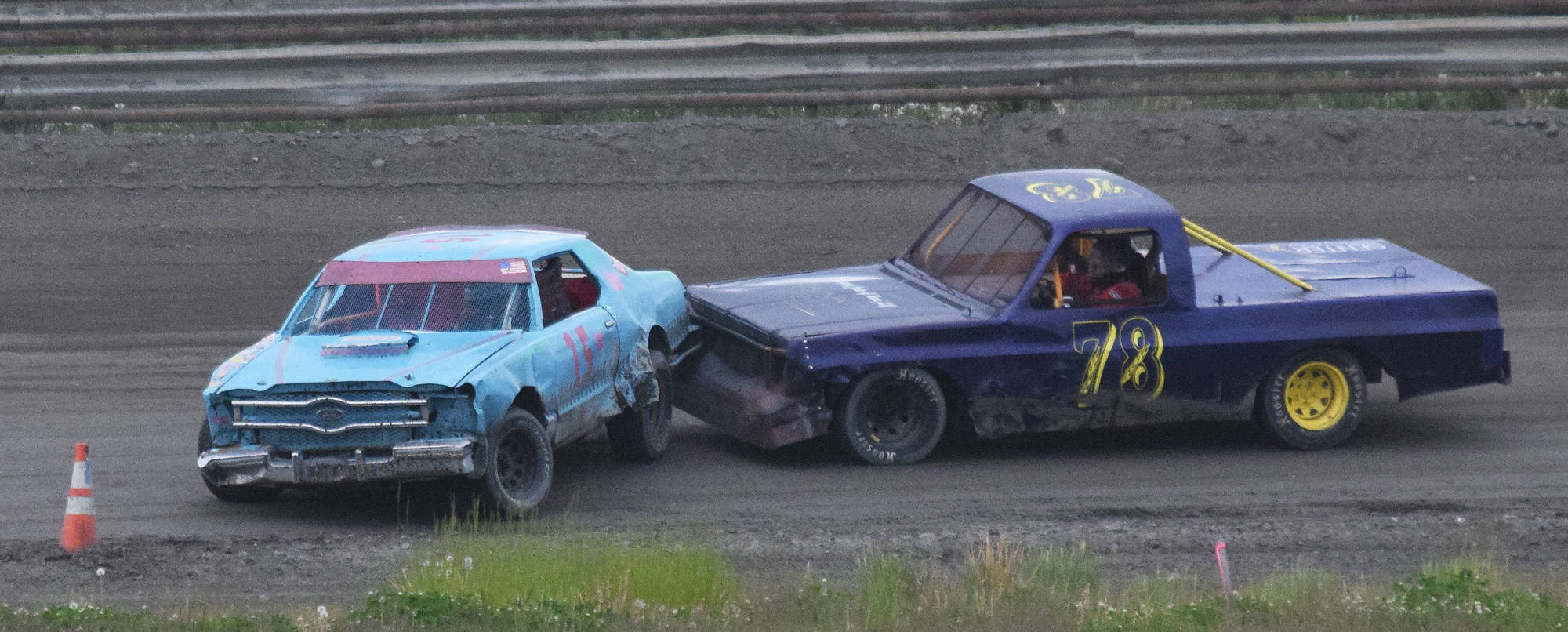 Butch Savely (78) gives Jeremy Euchuck a bump in the 50-lap “Filthy Fifty” feature event Saturday night at Twin City Raceway in Kenai. (Photo by Joey Klecka/Peninsula Clarion)