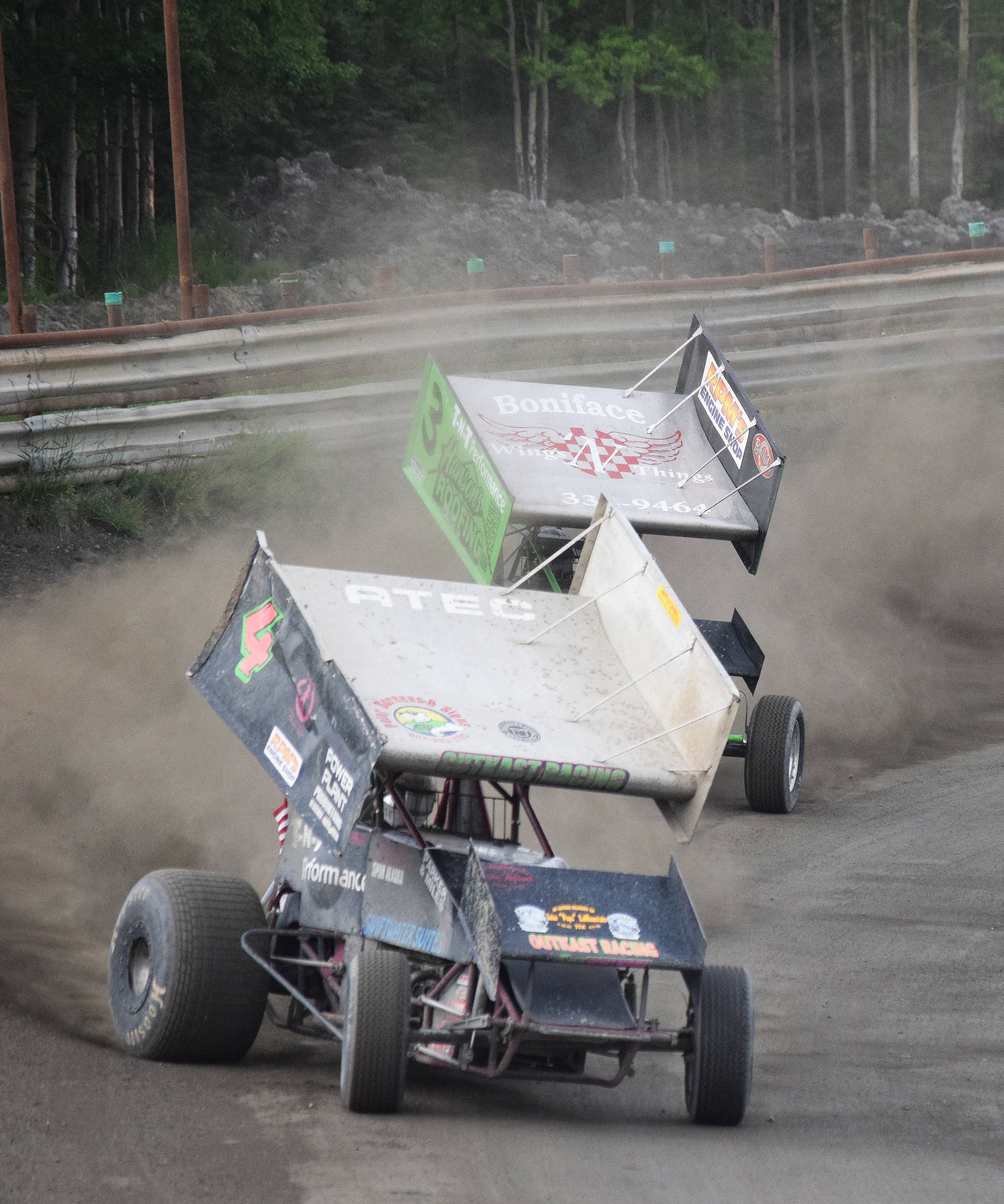 Sprint car racers slide around the turns Saturday night at Twin City Raceway in Kenai. The highlight of the weekend was the “Filthy Fifty” feature race Saturday night, which pitted A- and B-Stock racers against each other for 50 laps. Racing resumes today at 1 p.m. (Photo by Joey Klecka/Peninsula Clarion)