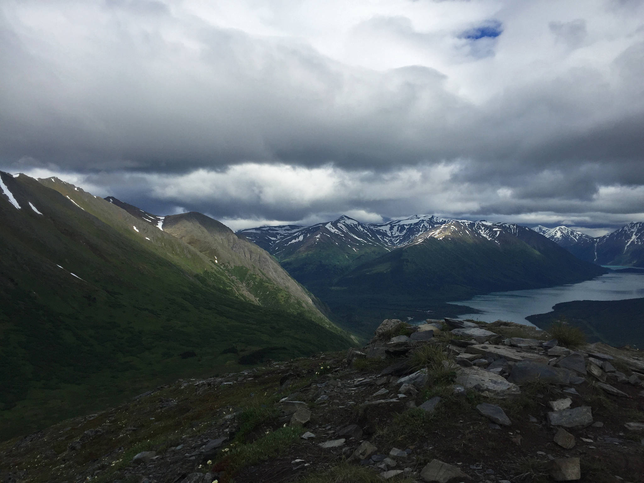 Clouds drift above the peak of Slaughter Ridge and Kenai Lake on Saturday, July 1, 2017 near Cooper Landing, Alaska. Southcentral Alaska so far has had a cool, wet summer, and may see below-normal temperatures with above-normal precipitation over the next eight to 14 days, according to the U.S. Climate Prediction Center. Sunday was rainy on the central peninsula, with temperatures hovering in the mid-50s. However, the sun is predicted to make a steadier appearance for the Fourth of July week, with temperatures rising to the low 60s by Tuesday and some sunshine, according to a Special Weather Statement from the National Weather Service. “The warm and mostly dry weather pattern looks like it will hold through at least the end of the week,” the announcement states. “There may still be some afternoon and evening showers and thunderstorms forming on area mountains, but sunshine will be abundant for the valleys.” (Photo by Elizabeth Earl/Peninsula Clarion)