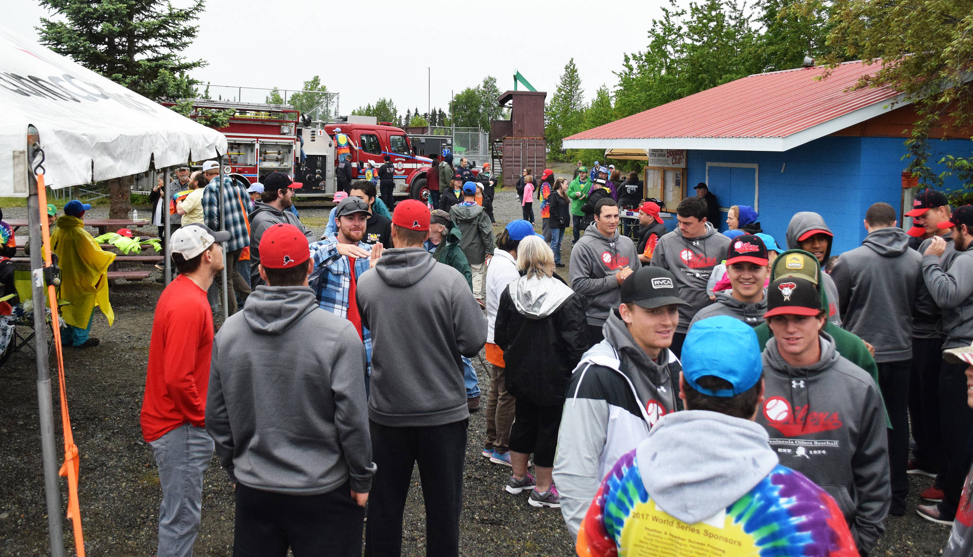 Peninsula Oilers players and Frontier Community Services clients gather for a friendly meet-and-greet barbeque June 29 at the Soldotna Little League fields. (Photo by Joey Klecka/Peninsula Clarion)