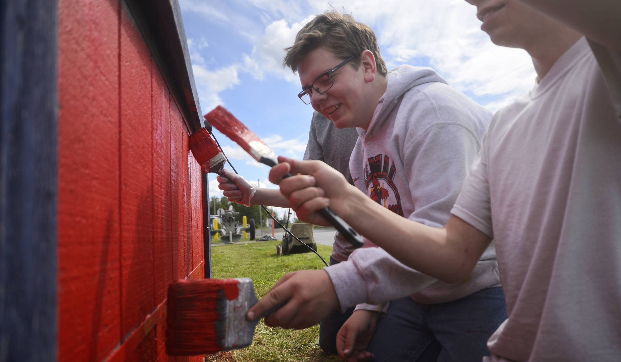 Eagle Scout candidate Derek Brown and fellow members of Kenai’s Boy Scout Troop 152 Joey Freeman (left) and Jimmy Freeman (right) paint the flower box outside Kenai’s American Legion post as part of Brown’s Eagle Scout community service project on Monday, July 10, 2017 in Kenai, Alaska. To earn Boy Scouting’s highest rank, Brown organized the troop, along with friends and family members, in repainting the flower box red, white, and blue, and planting it with a pattern of red, white, and blue flowers, along with purple petunias to symbolize the Purple Heart military decoration given to wounded soldiers. Brown, who began planning the project about two weeks ago, said his two brothers had previously done Eagle Scout projects to benefit schools and churches. “I wanted to do something for the veterans, and this was the best I could come up with,” Brown said.