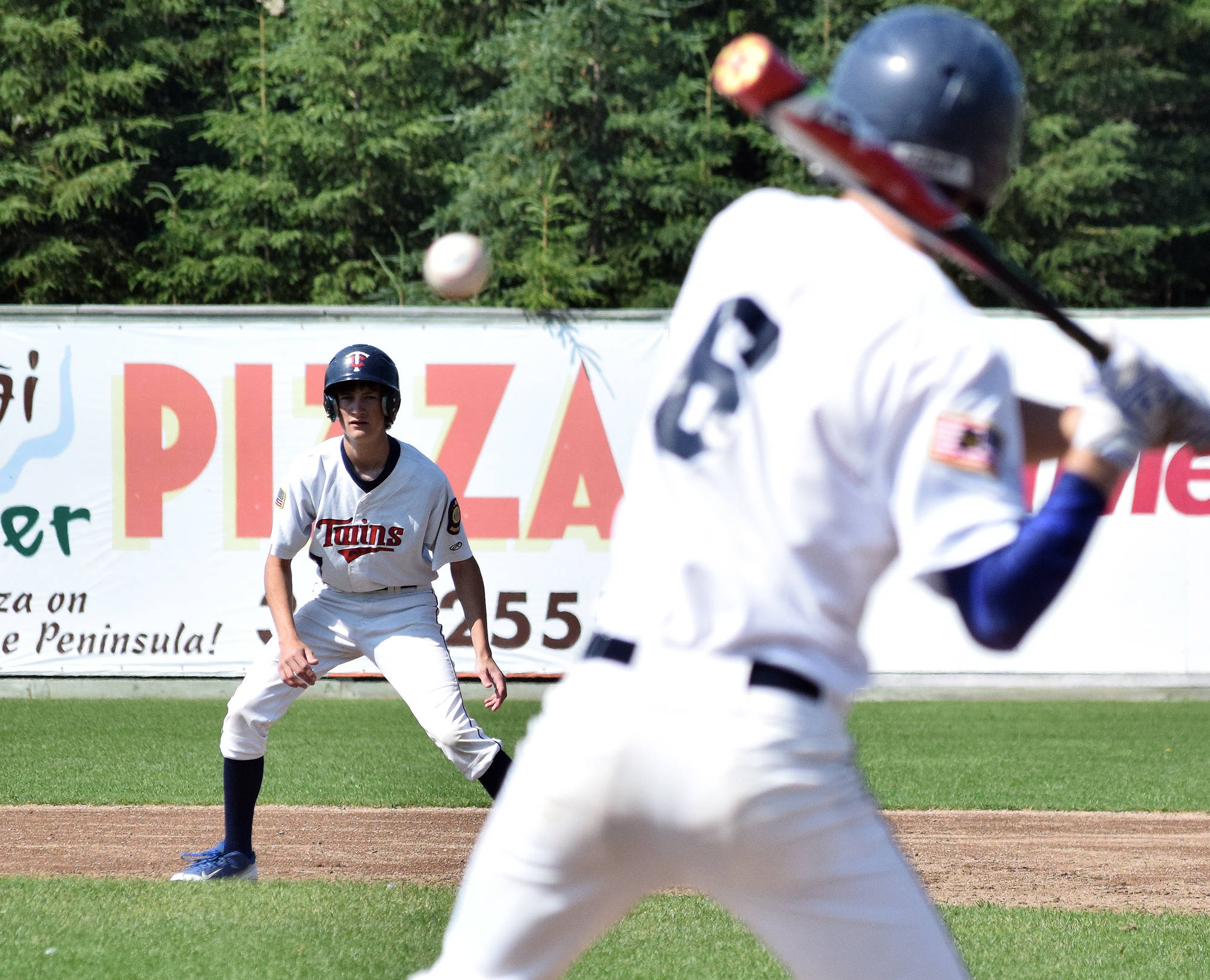 Twins outfielder David Belger keeps an eye on teammate Joe Ravin Wednesday against Post 33 Chugiak at Coral Seymour Memorial Ballpark in Kenai. (Photo by Joey Klecka/Peninsula Clarion)