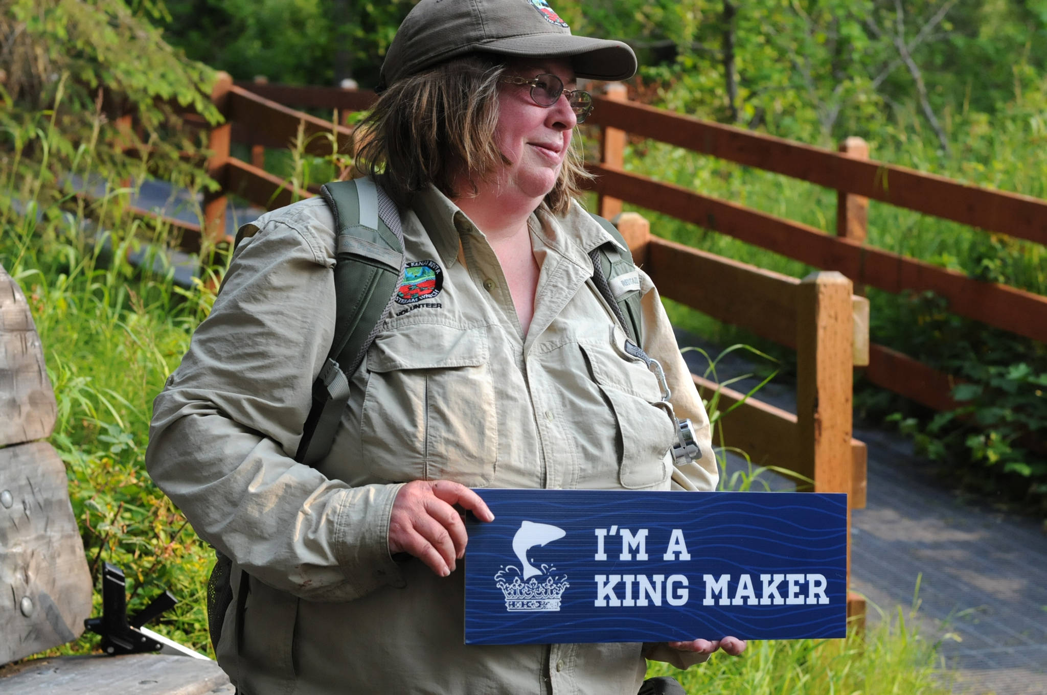 Kathy Heindle, a Kenai Peninsula Stream Watch volunteer, holds a sign designating her as a winner of the Kingmaker Award from the Kachemak Heritage Land Trust in Centennial Park on Thursday, July 13, 2017 in Soldotna, Alaska. Heindle, who has been volunteering with Stream Watch since 2011, received a “Kingmaker” award from the Kachemak Heritage Land Trust for her work protecting the Kenai River watershed. (Photo by Elizabeth Earl/Peninsula Clarion) Kathy Heindle, a Kenai Peninsula Stream Watch volunteer, holds a sign designating her as a winner of the Kingmaker Award from the Kachemak Heritage Land Trust in Centennial Park on Thursday, July 13, 2017 in Soldotna, Alaska. Heindle, who has been volunteering with Stream Watch since 2011, received a “Kingmaker” award from the Kachemak Heritage Land Trust for her work protecting the Kenai River watershed. (Photo by Elizabeth Earl/Peninsula Clarion)