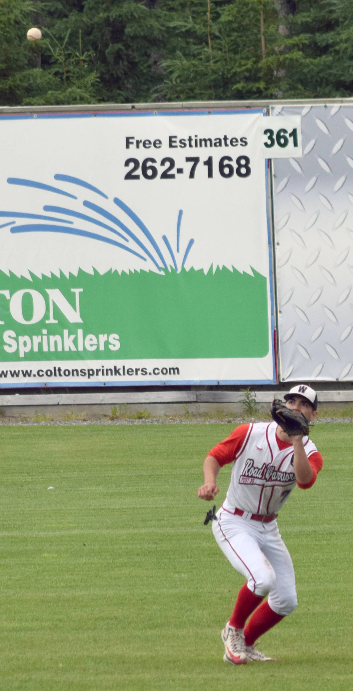 Wasilla Road Warriors right fielder Sam Reed prepares to haul in a fly from Mose Hayes of the Twins in the fourth inning of the first game of a doubleheader at Coral Seymour Memorial Park in Kenai on Sunday, July 16, 2017. (Photo by Jeff Helminiak/Peninsula Clarion)