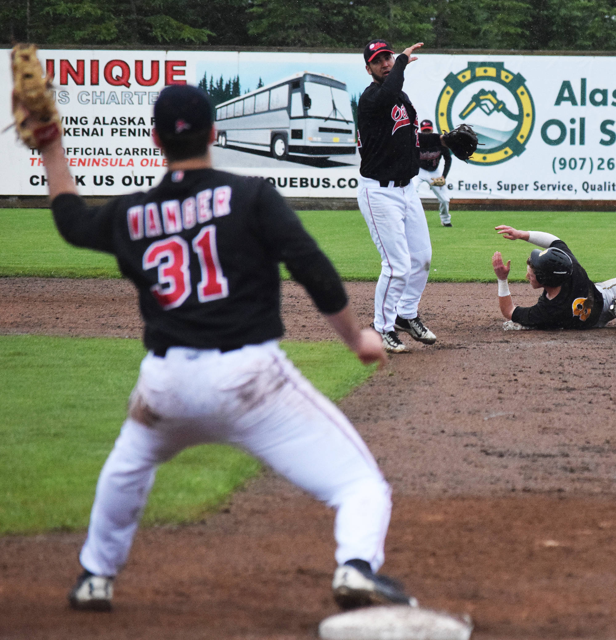 Peninsula Oilers second baseman Ryan Smith lobs a double play throw to first baseman Benjamin Wanger against the Anchorage Bucs Wednesday night at Coral Seymour Memorial Park in Kenai. (Photo by Joey Klecka/Peninsula Clarion) Peninsula Oilers second baseman Ryan Smith lobs a double play throw to first baseman Benjamin Wanger against the Anchorage Bucs Wednesday night at Coral Seymour Memorial Ballpark in Kenai. (Photo by Joey Klecka/Peninsula Clarion)