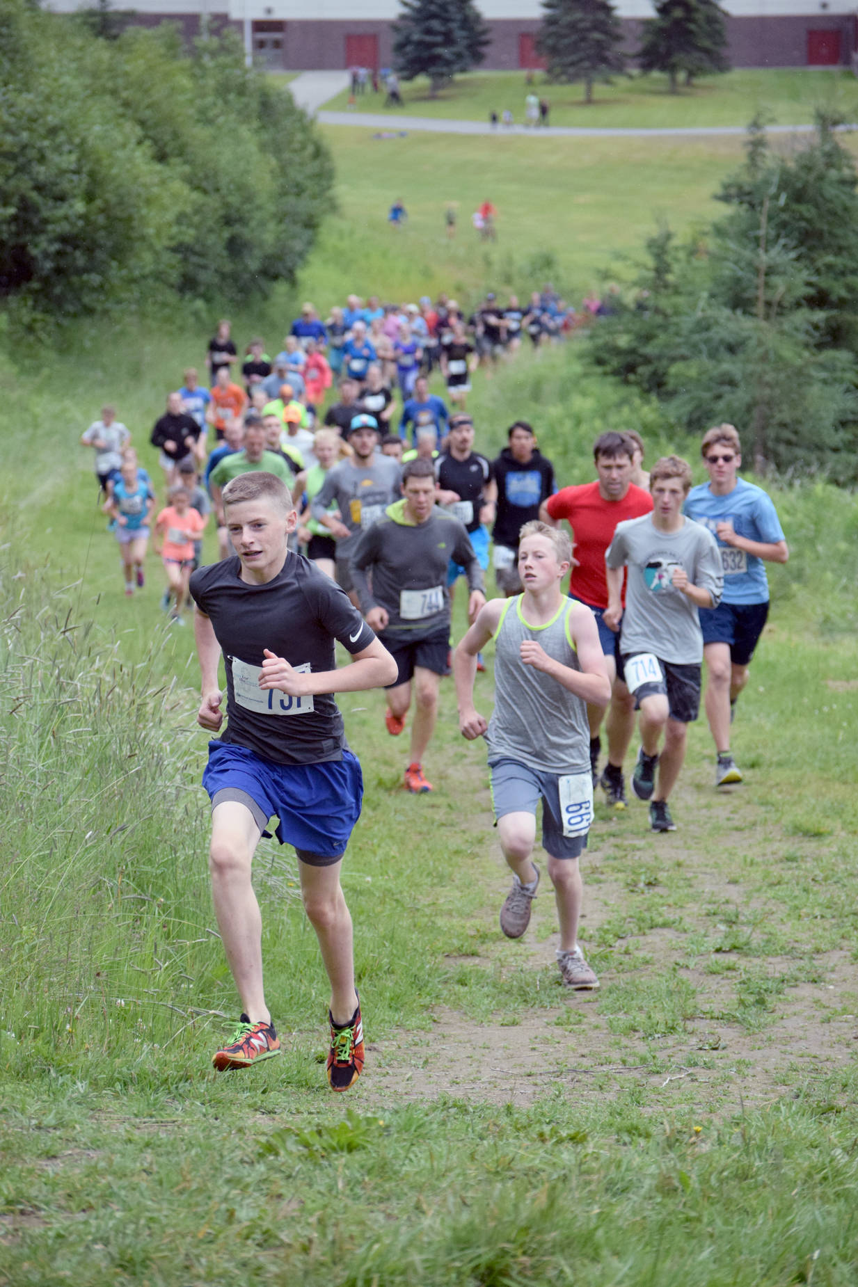 Lance Chilton leads the pack in the five-kilometer Salmon Run Series race up Angle Hill on Wednesday, July 19, 2017, at Tsalteshi Trails in Soldotna. Chilton would hold on to take the victory. (Photo by Jeff Helminiak/Peninsula Clarion)