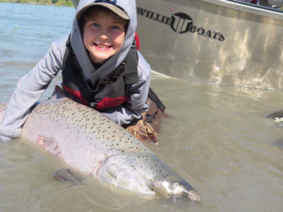 In this photo submitted to Fish for the Future, a young angler holds up the king salmon he caught and released. Fish for the Future, a program begun by two central Kenai Peninsula guides, offers prizes for people who submit photographs of king salmon they caught and released on the Kenai and Kasilof rivers in June and July as a way to encourage people to release fish and conserve the fishery over time. (Photo courtesy Fish for the Future)