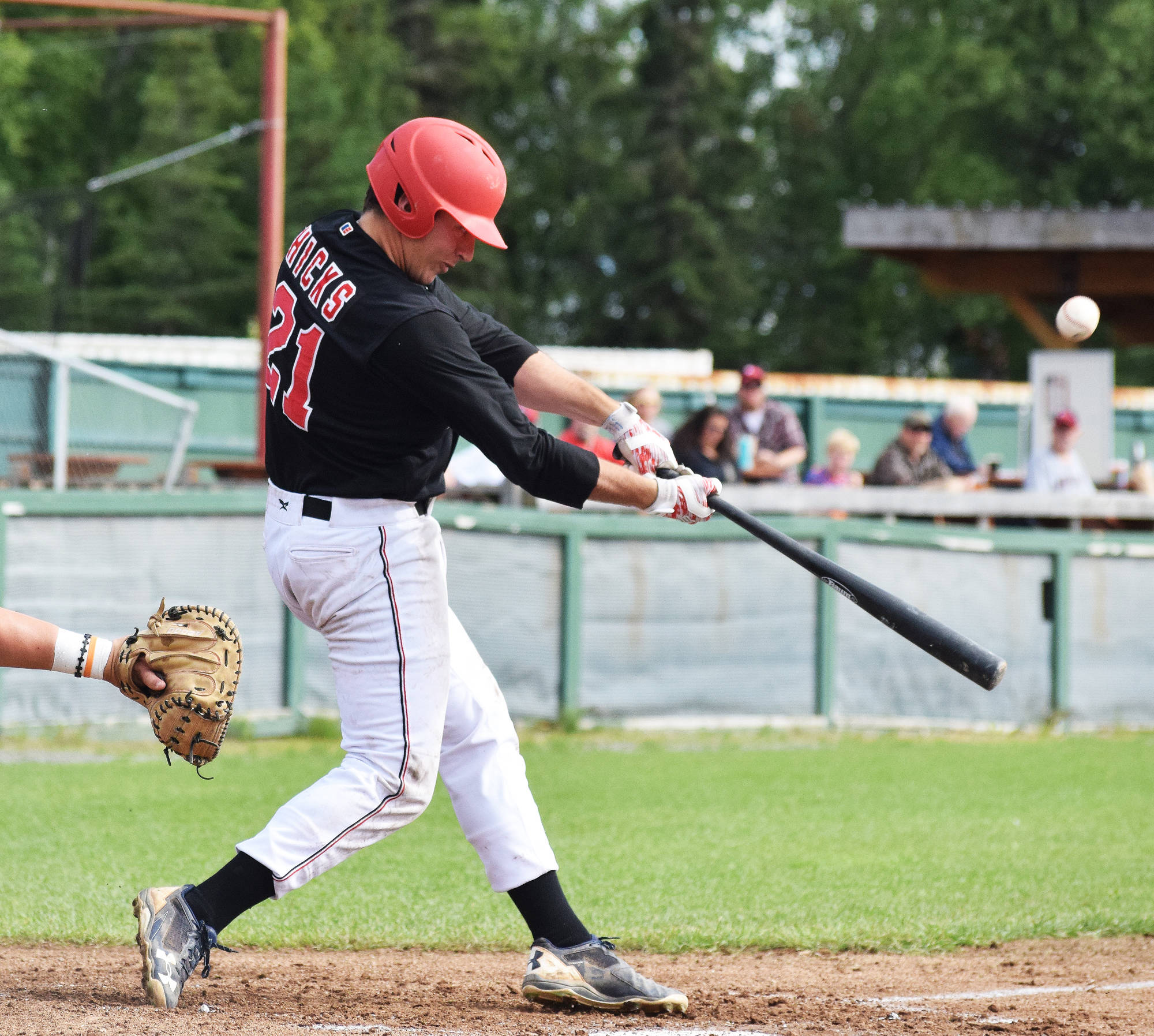 Peninsula Oilers third baseman Caleb Hicks connects with a pitch from Anchorage Bucs starter Seth Kaneen Thursday at Coral Seymour Memorial Ballpark in Kenai. (Photo by Joey Klecka/Peninsula Clarion) Peninsula Oilers third baseman Caleb Hicks connects with a pitch from Anchorage Bucs starter Seth Kaneen on Thursday, July 20, 2017, at Coral Seymour Memorial Park in Kenai. (Photo by Joey Klecka/Peninsula Clarion)