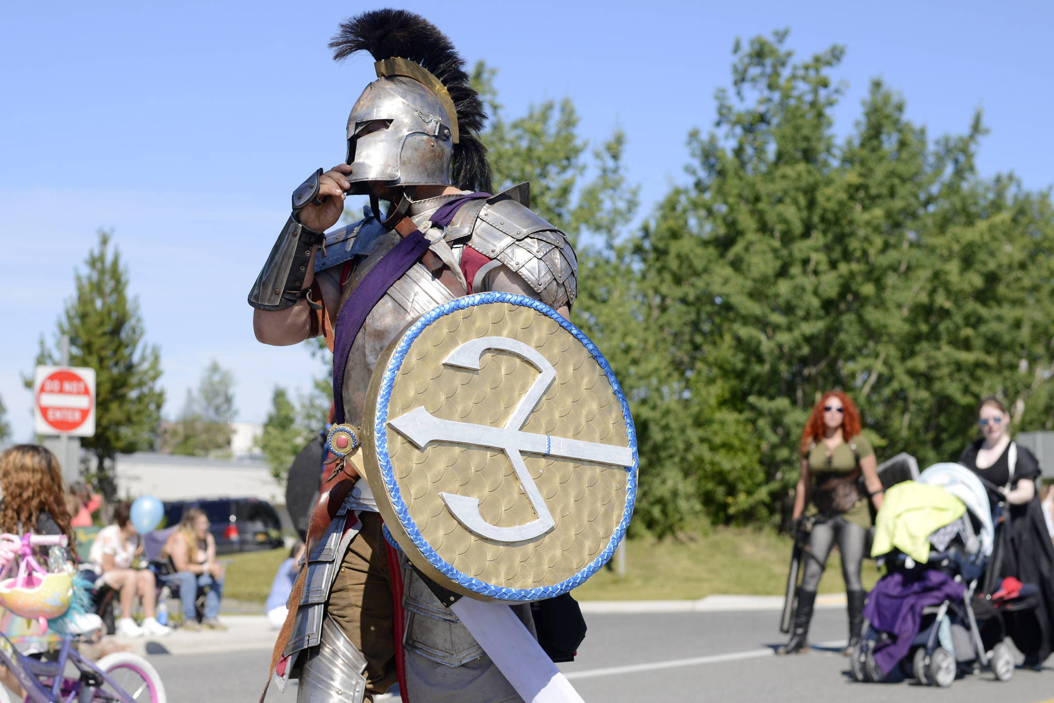Dressed in armor, a member of the live-action roleplaying group Frozen Coast marches in the Soldotna Progress Days Parade on Saturday, July 22, 2017 in Soldotna, Alaska.