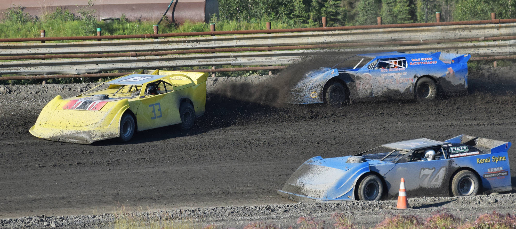 Jason Magers (33) kicks up dirt onto the windshielf of a fellow Late Models racer as Al Ulman (74) drives by during the running of the Alaska Dirt Track Shootout held Saturday at Twin City Raceway in Kenai. (Photo by Joey Klecka/Peninsula Clarion)