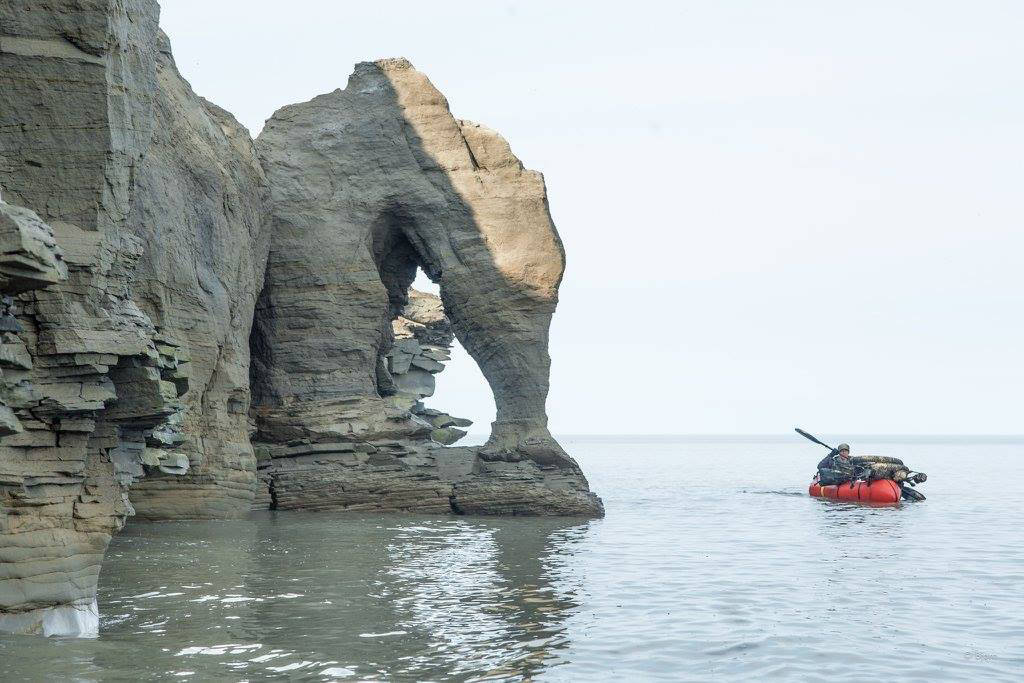 Kim McNett paddling by the Skull Cliffs south of Barrow. (Photo courtesy Bj&