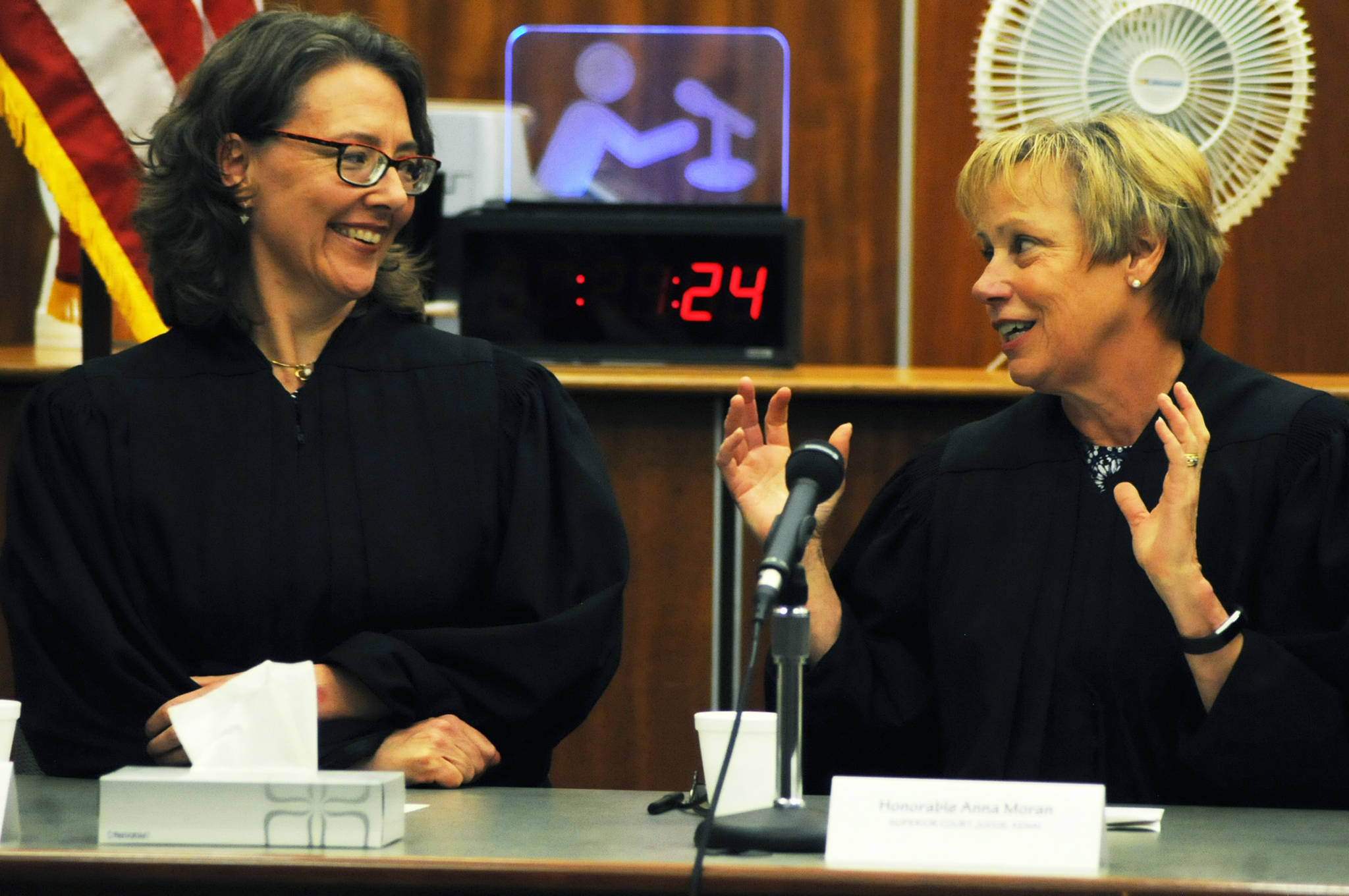 Kenai Superior Court Judge Anna Moran (right) offers congratulations and advice to newly installed Superior Court Judge Jennifer Wells (left) during Wells’ installation ceremony Thursday, July 27, 2017 in Kenai, Alaska. Wells, a 22-year veteran of the Alaska court system, replaces former Superior Court Judge Carl Bauman, who retired in February. (Photo by Elizabeth Earl/Peninsula Clarion)