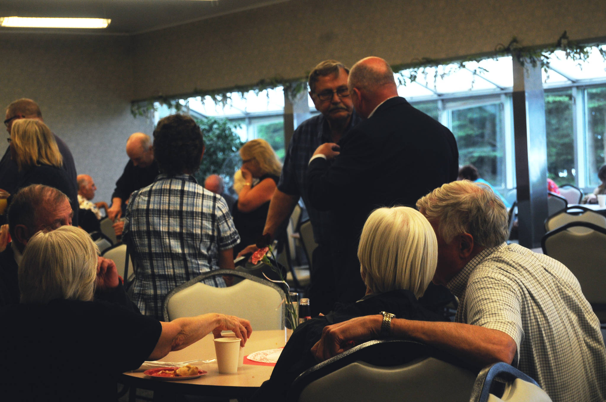 A couple chats at a table at the 50th Kenai Central High School Class of 1967 reunion at the Kenai Senior Center on Friday, July 28, 2017 in Kenai, Alaska. The reunion was organized to mark the ‘67 graduating class’s reunion, though classes from the ’60s, ’50s and the days of the Territorial School before that were also welcome. (Photo by Elizabeth Earl/Peninsula Clarion)