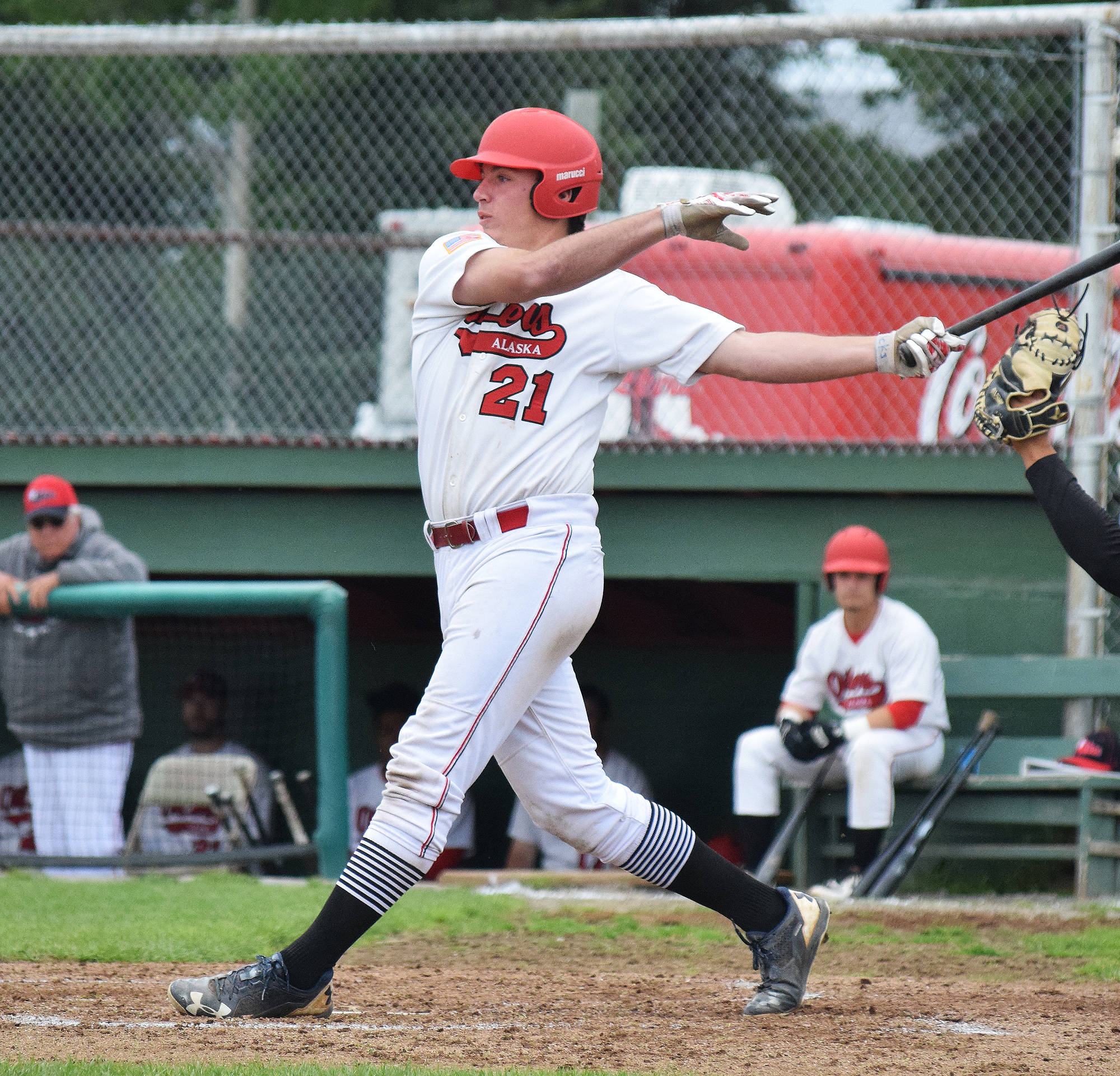 Caleb Hicks tips a foul ball off the Chugiak Chinooks in a July 28 game at Coral Seymour Memorial Ballpark in Kenai. (Photo by Joey Klecka/Peninsula Clarion)