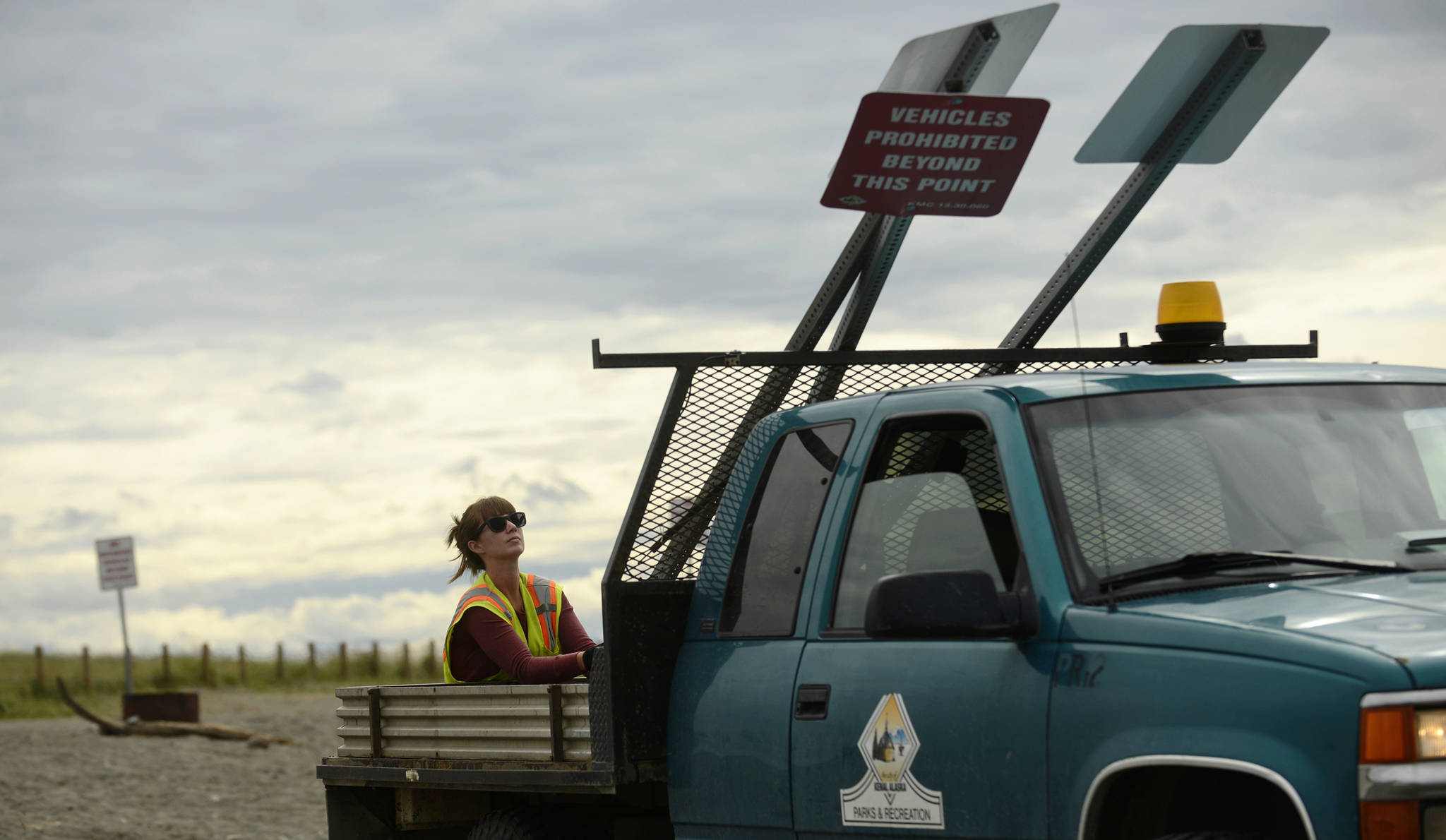 Alinna Granados of the Kenai Parks and Recreation Department takes down beach signs after the end of the personal use dipnet fishery on Tuesday, August 1, 2017 on Kenai’s north beach. Granados and fellow Parks and Rec employee Randy Dodge, who used a loader to pull the signs from the sand, took down signage and barriers after the beach had been cleaned of trash and fish waste earlier that morning. Alinna Granados of the Kenai Parks and Recreation Department takes down beach signs after the end of the personal use dipnet fishery on Tuesday, August 1, 2017 on Kenai’s north beach. Granados and fellow Parks and Rec employee Randy Dodge, who used a loader to pull the signs from the sand, took down signage and barriers after the beach had been cleaned of trash and fish waste earlier that morning.