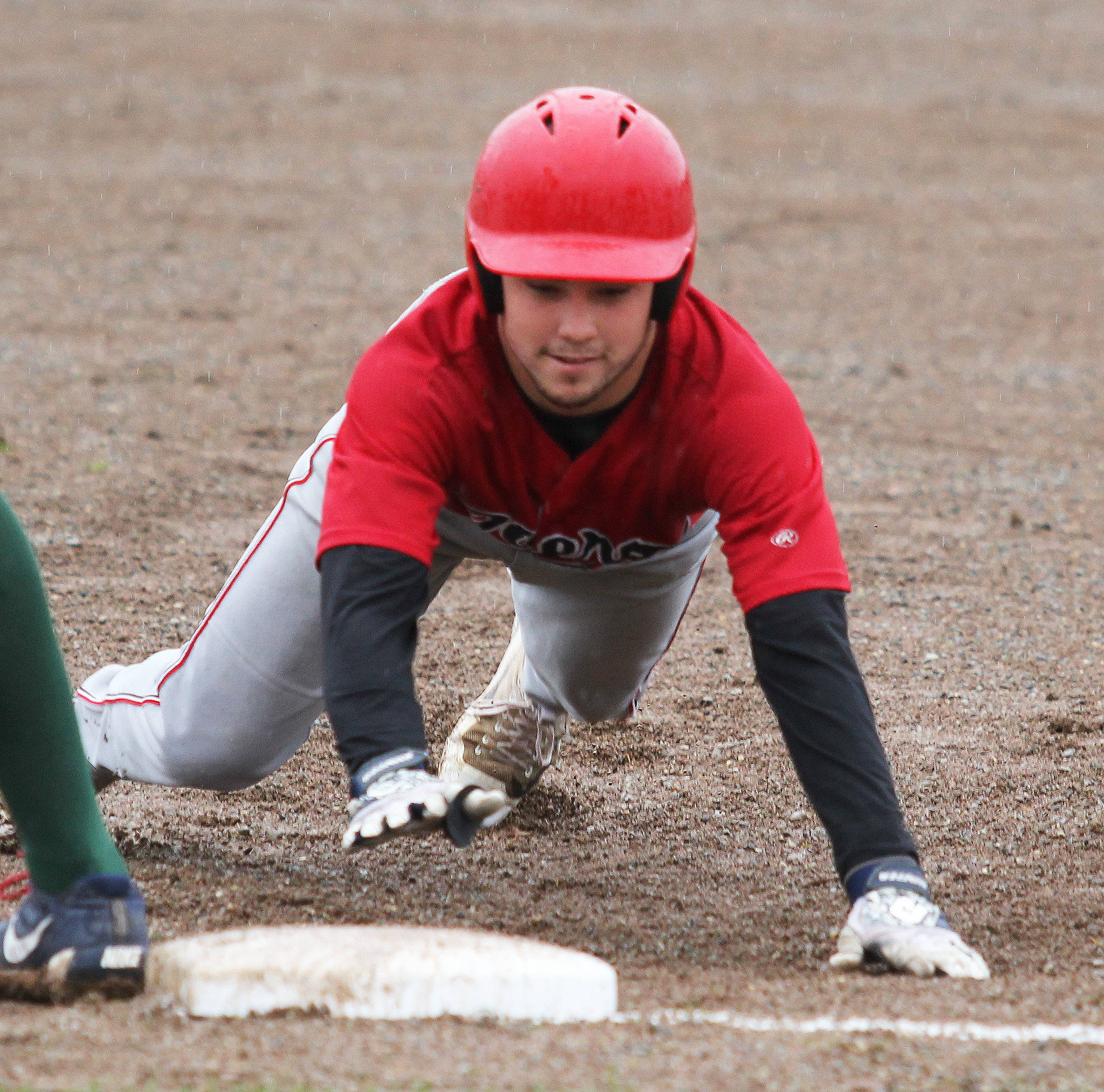 Peninsula infielder Paul Kunst slides back into first during a 3-1 loss ot Mat-Su in the first game of a best-of-3 semifinal series Wednesday at Hermon Brothers Field in Palmer. (Photo by Jeremiah Bartz/Mat-Su Frontiersman)