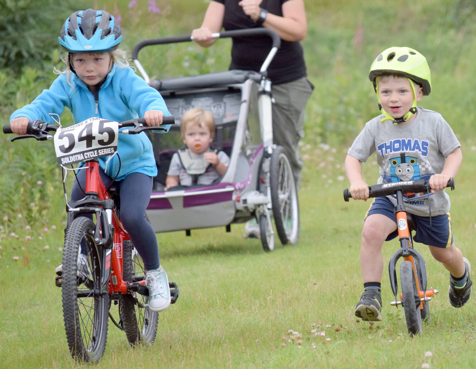 Rosemary Dura and Nathan Nelson compete during the kids race at the Soldotna Cycle Series on Thursday at Tsalteshi Trails. (Photo by Jeff Helminiak/Peninsula Clarion)