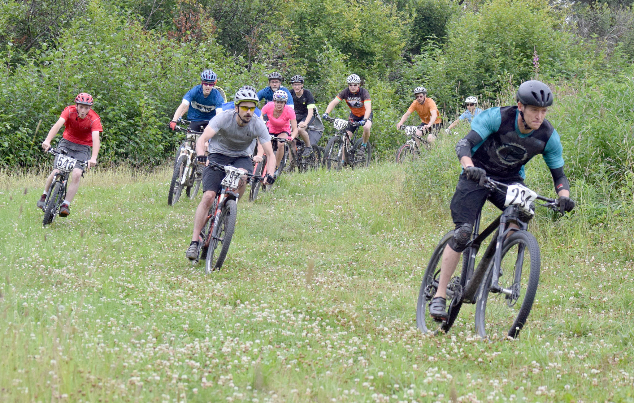Mike Crawford leads the pack off the start of Soldotna Cycle Series Race 6 on Thursday, Aug. 3, 2017, at Tsalteshi Trails. (Photo by Jeff Helminiak/Peninsula Clarion)