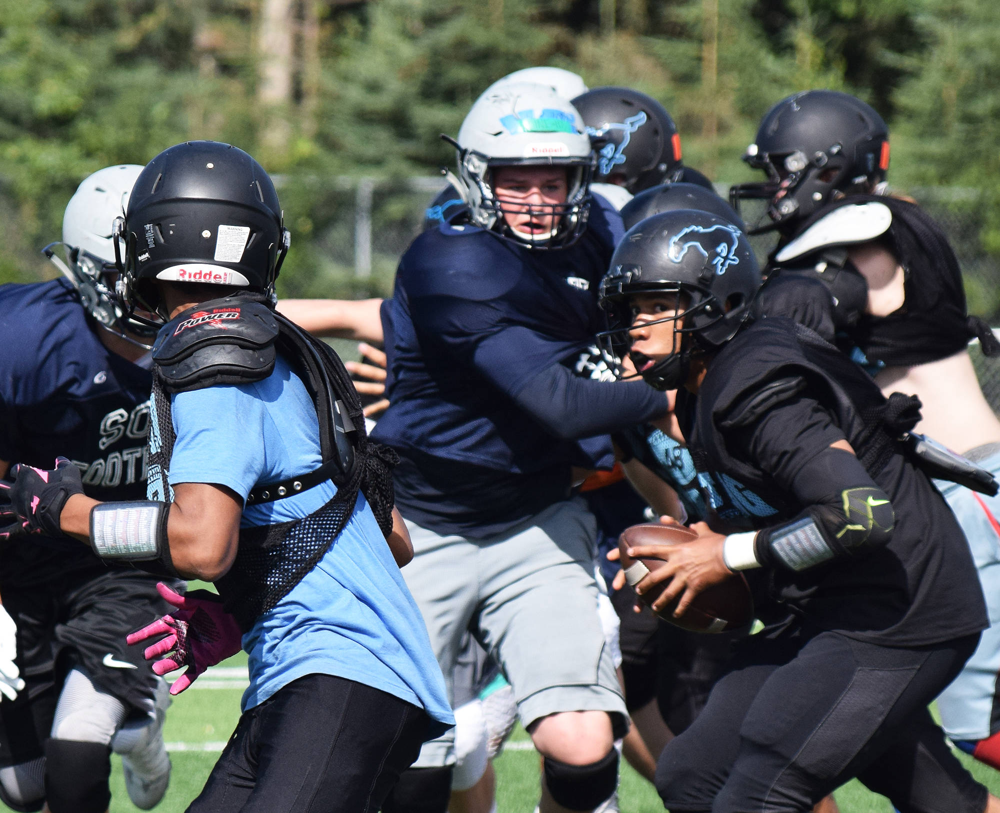 Varsity members of the Soldotna and Chugiak football teams clash Saturday in a preseason scrimmage at Justin Maile Field in Soldotna. (Photo by Joey Klecka/Peninsula Clarion)