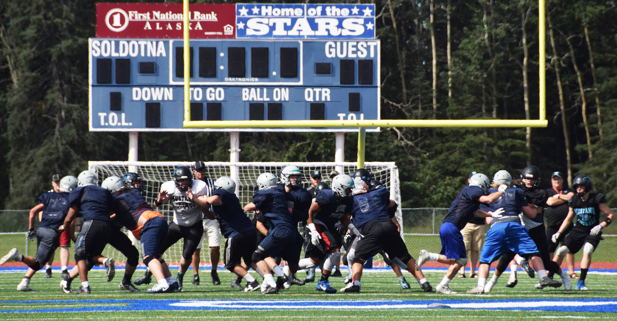 Members of the Chugiak and Soldotna football teams scrimmage Saturday at Justin Maile Field in Soldotna. (Photo by Joey Klecka/Peninsula Clarion)